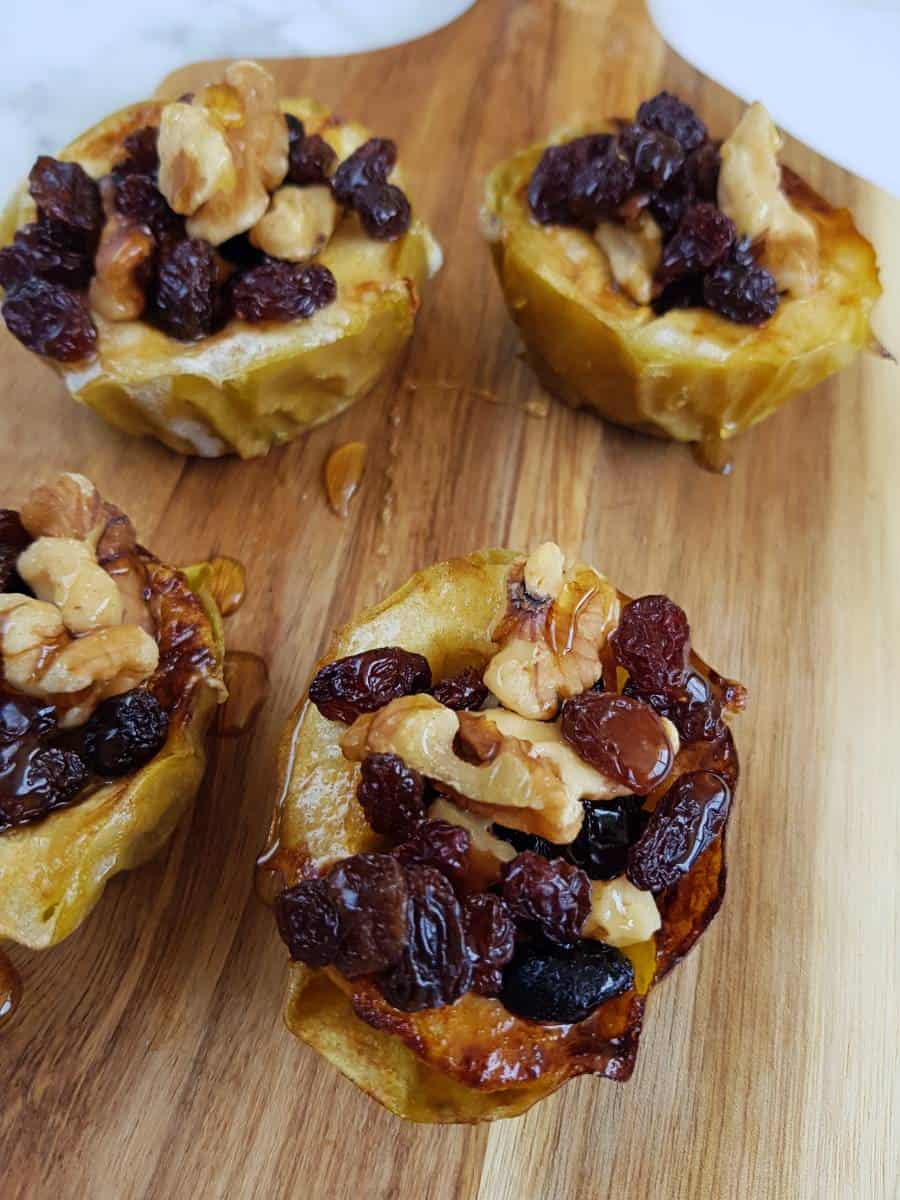 Air fryer baked apples on wooden board.