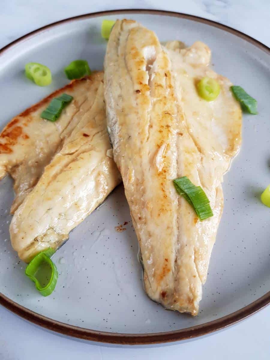 Miso sea bass fillets on a plate.