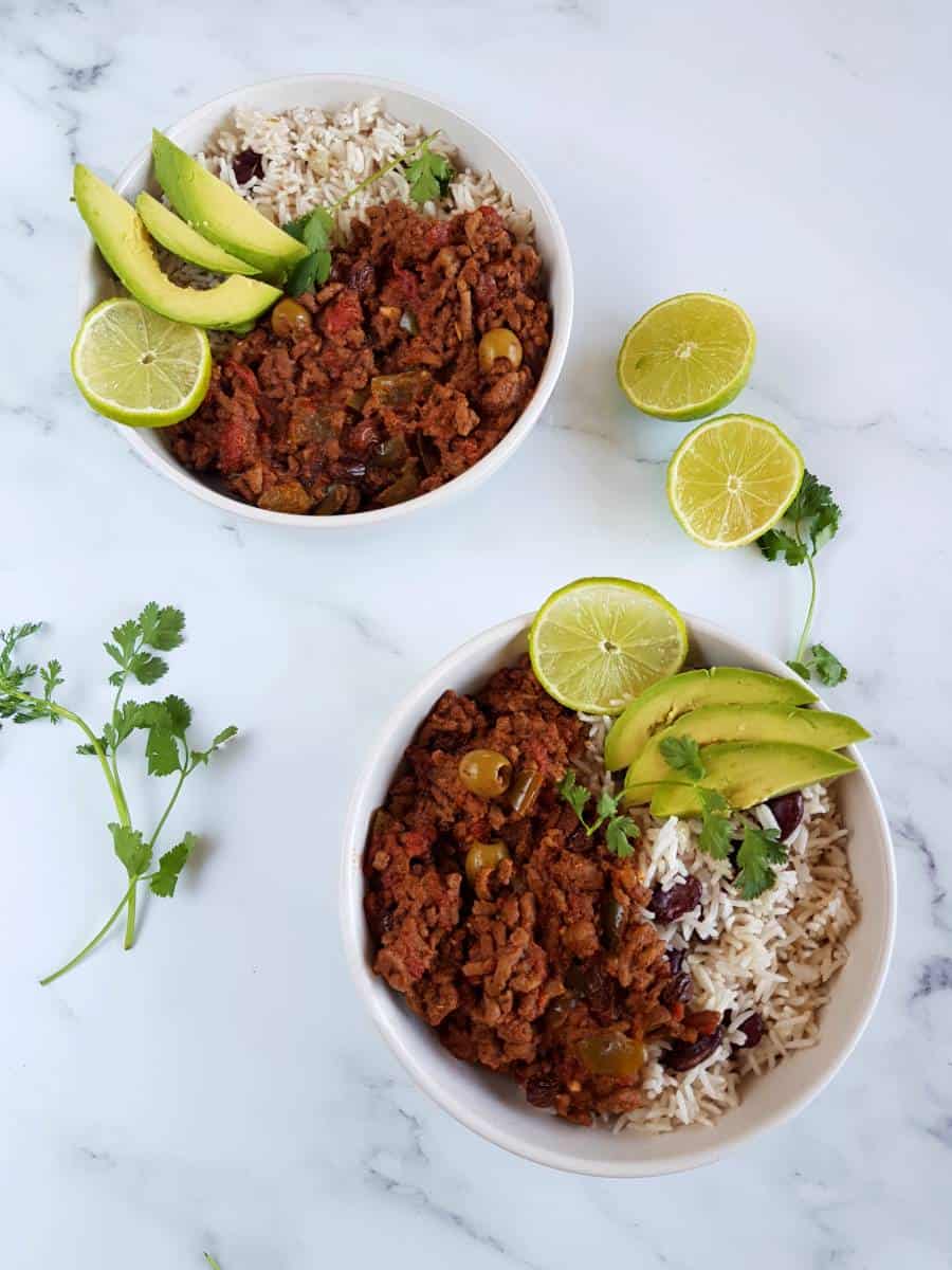 Picadillo with rice avocado and lime.