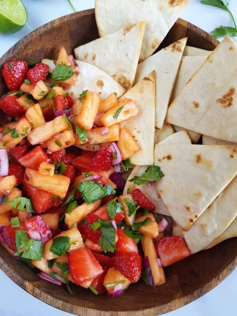 Pineapple strawberry salsa with tortilla chips.