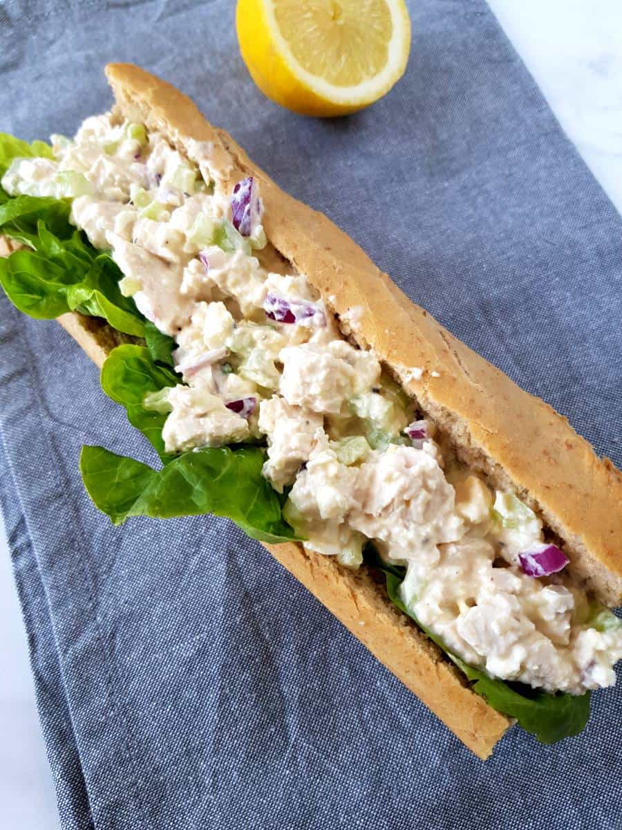 Southern style chicken salad in baguette on a table.