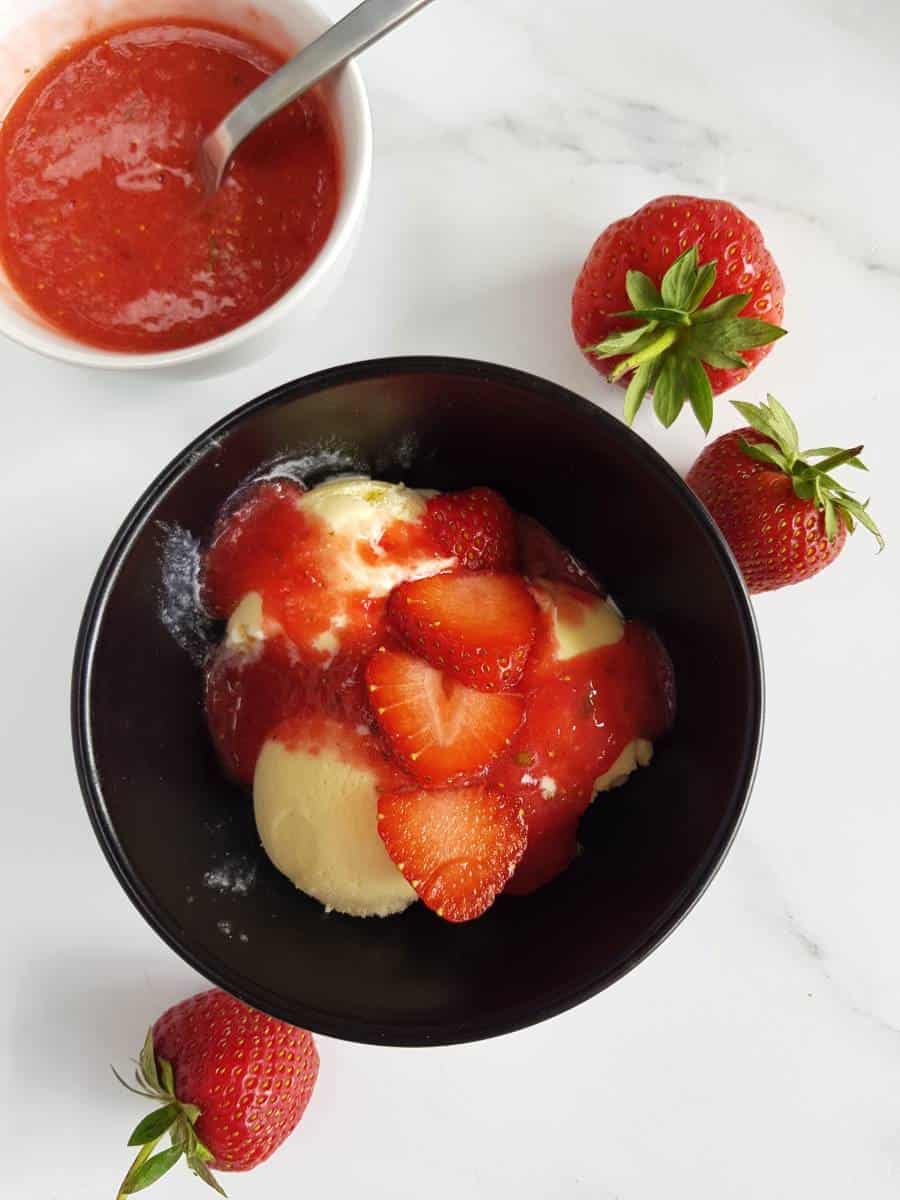 Strawberry sauce on ice cream.