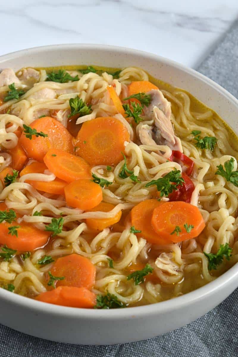 Chicken noodle soup with carrots.