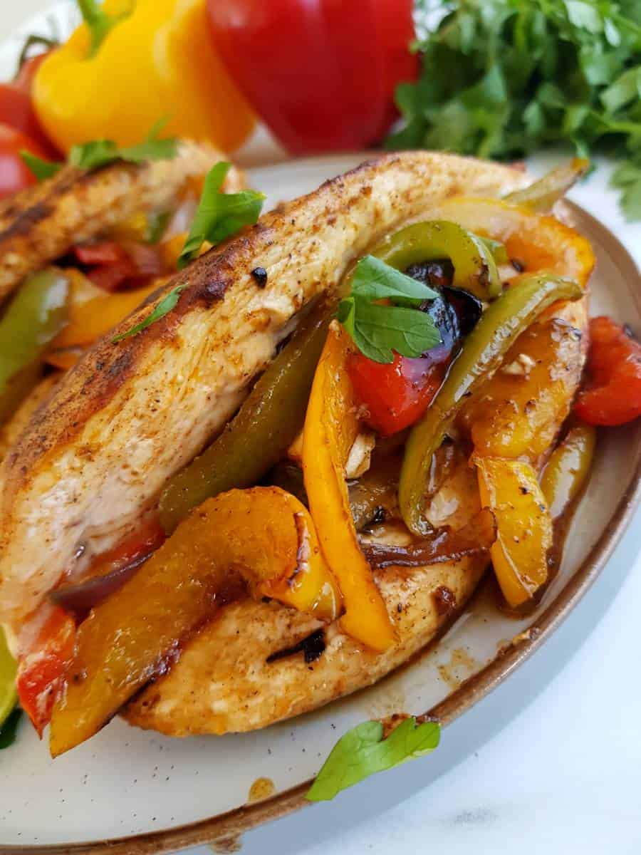 Chicken stuffed with peppers on a plate.