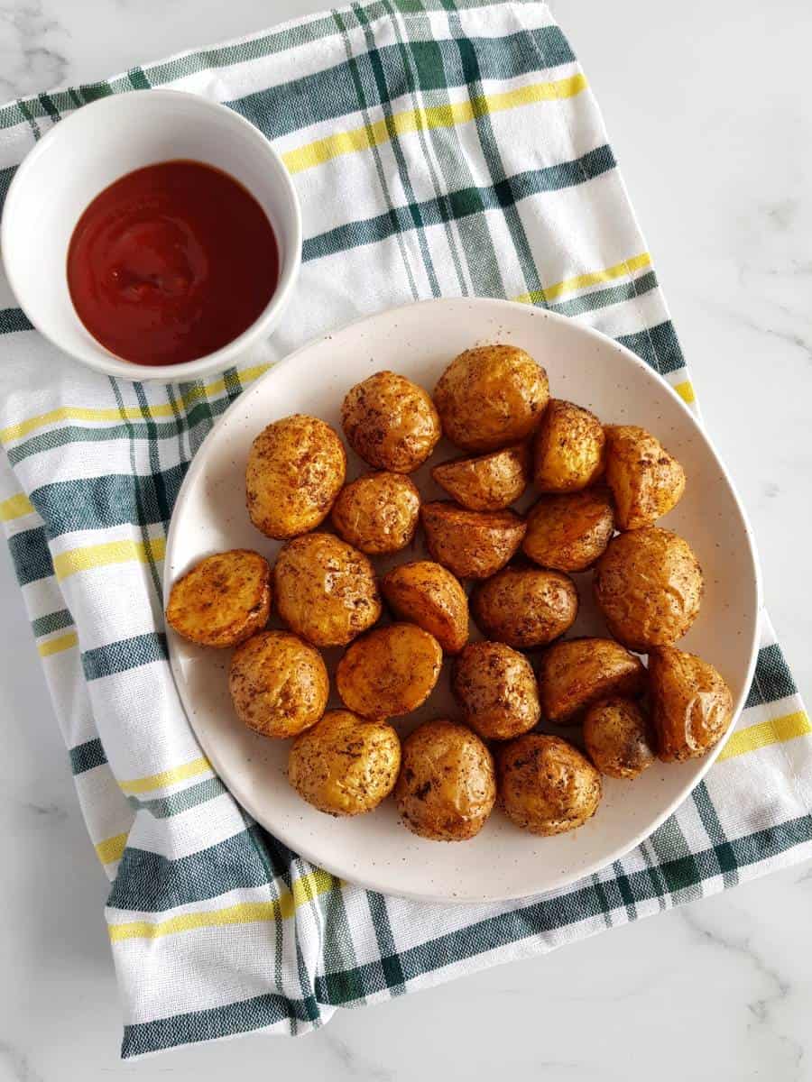 Crispy air fried potatoes with ketchup.