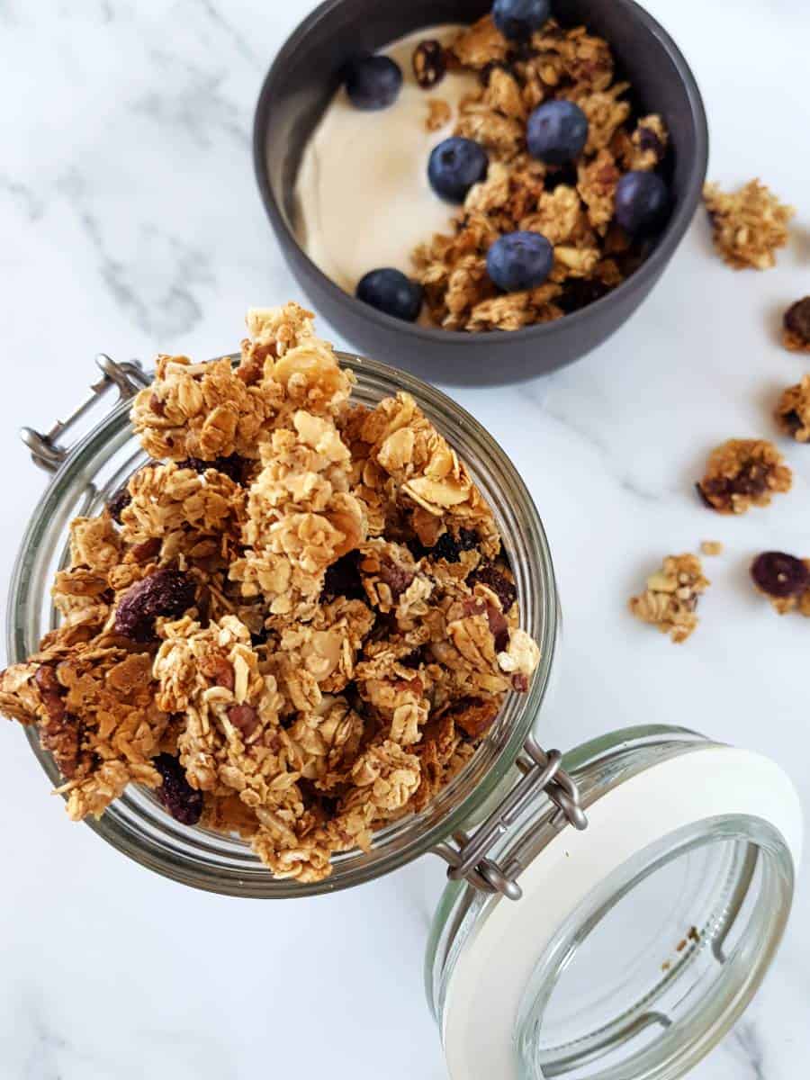 Granola with dried blueberries in a mason jar.