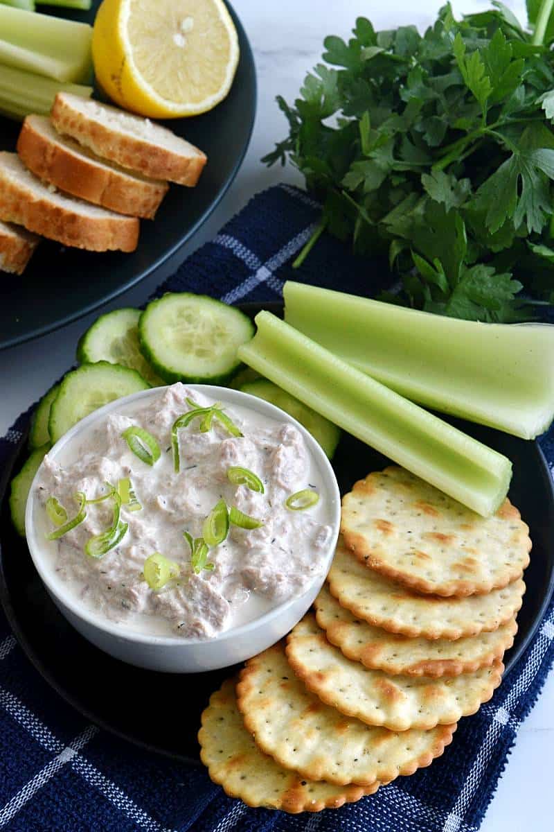 Healthy tuna dip with crackers and celery sticks.