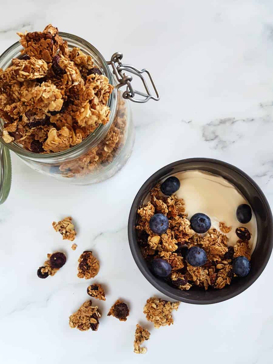 Homemade granola with blueberries in a bowl with yogurt.