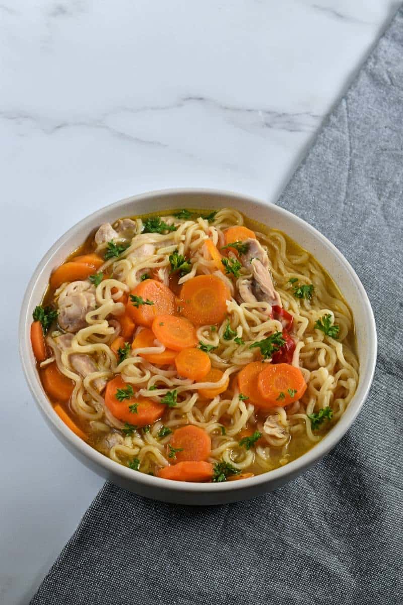 Noodle carrot chicken soup.