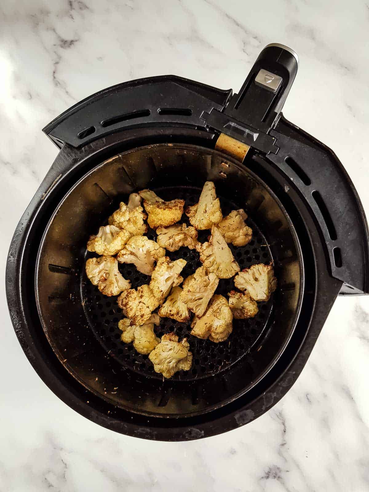 Roasted cauliflower in an air fryer.