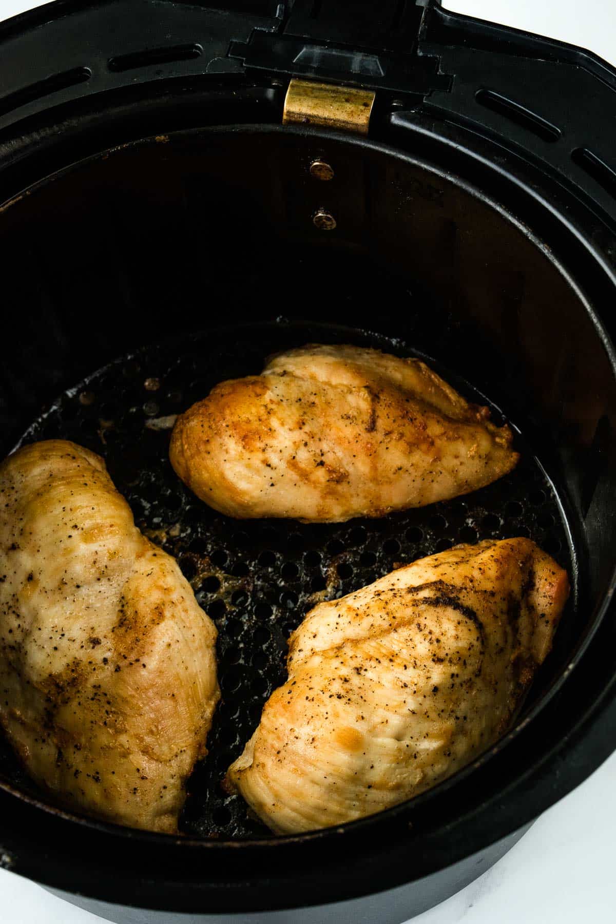 Chicken breasts in an air fryer.