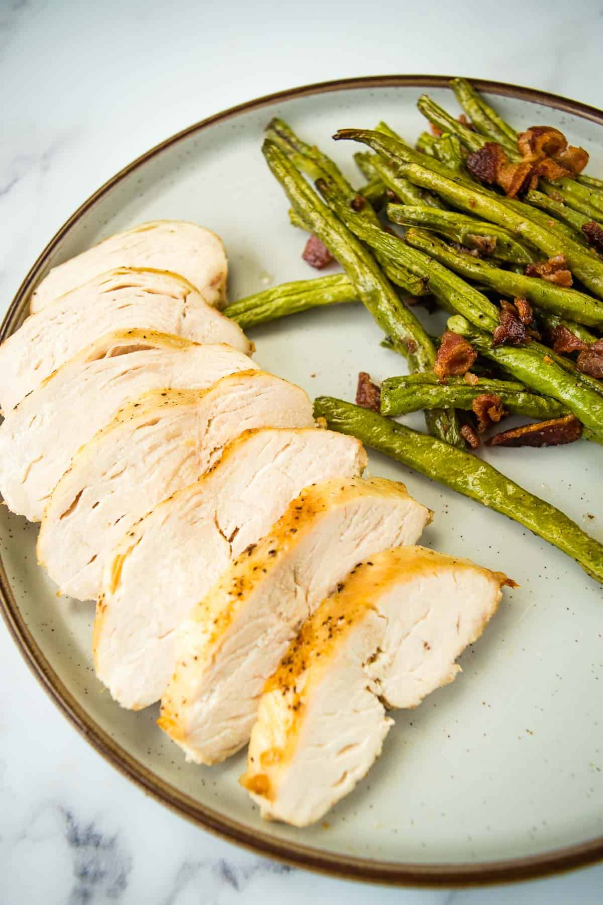 Sliced chicken breast with green beans.