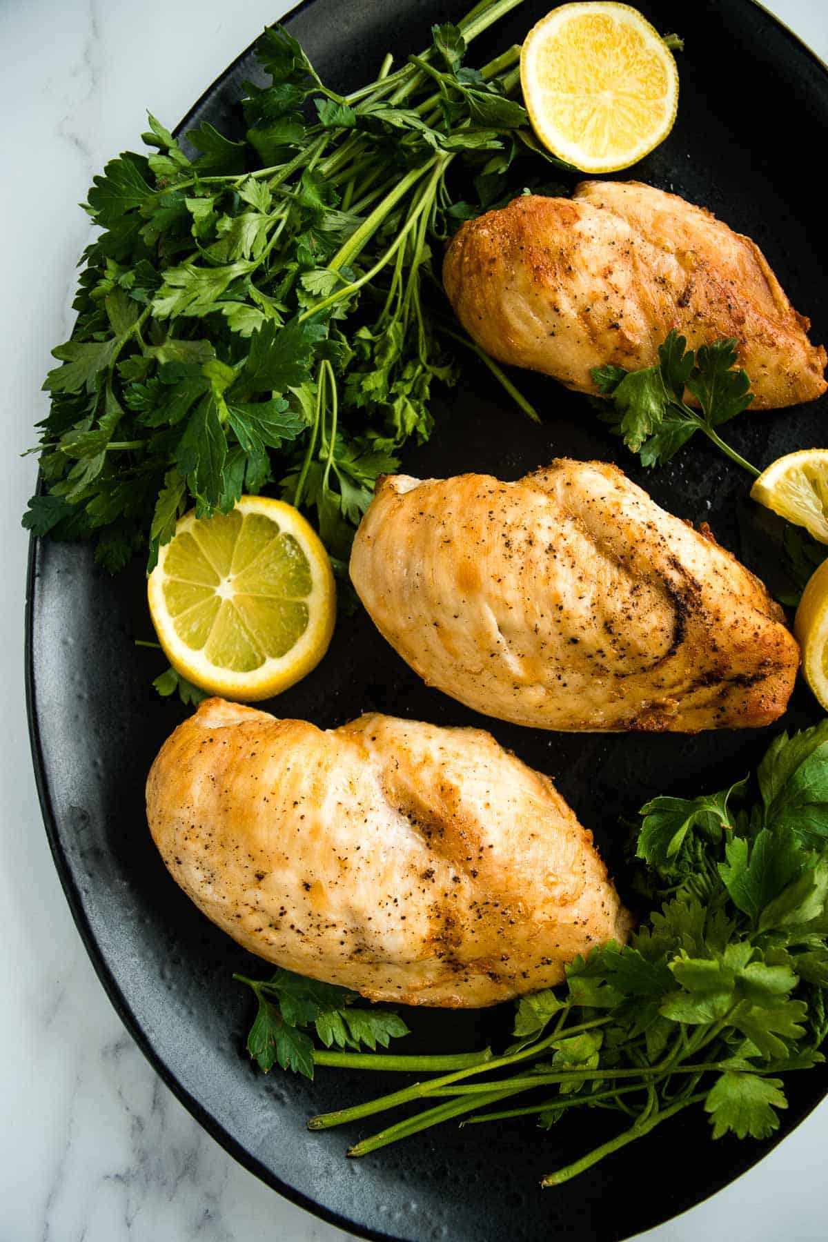 Air fried chicken breast fillets on a plate.