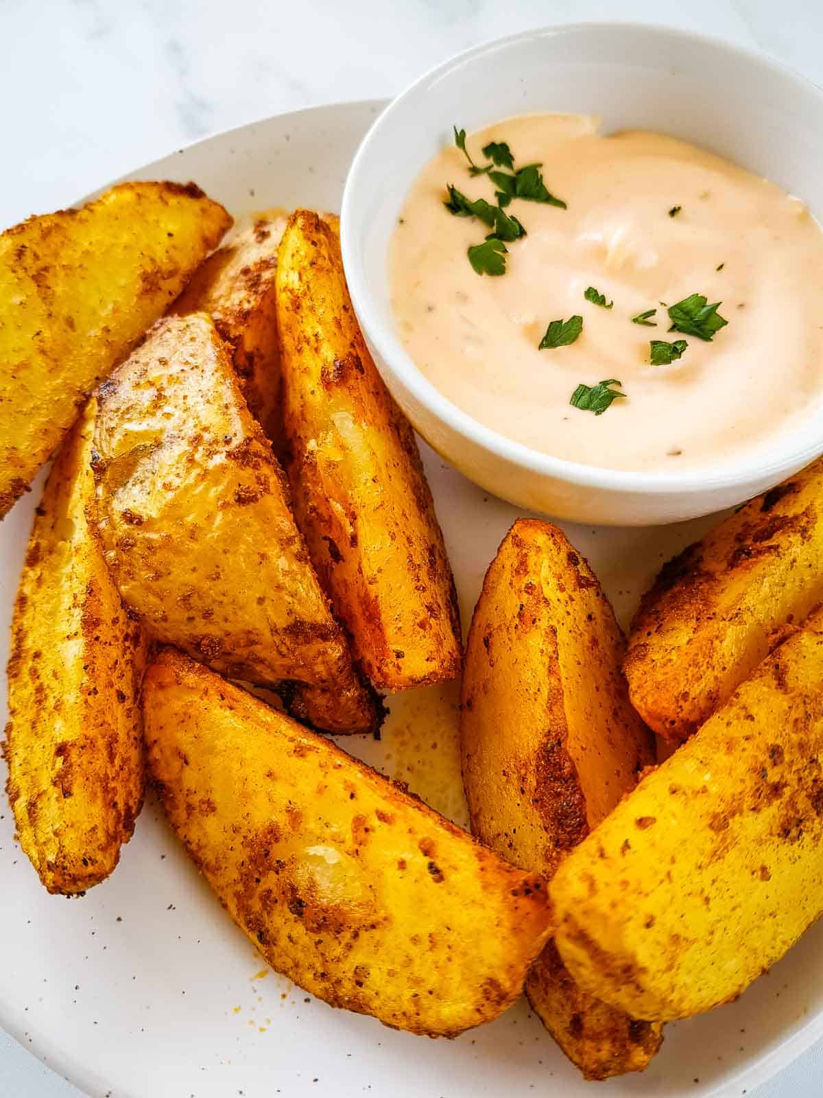 Crispy air fried potato wedges with aioli on the side.