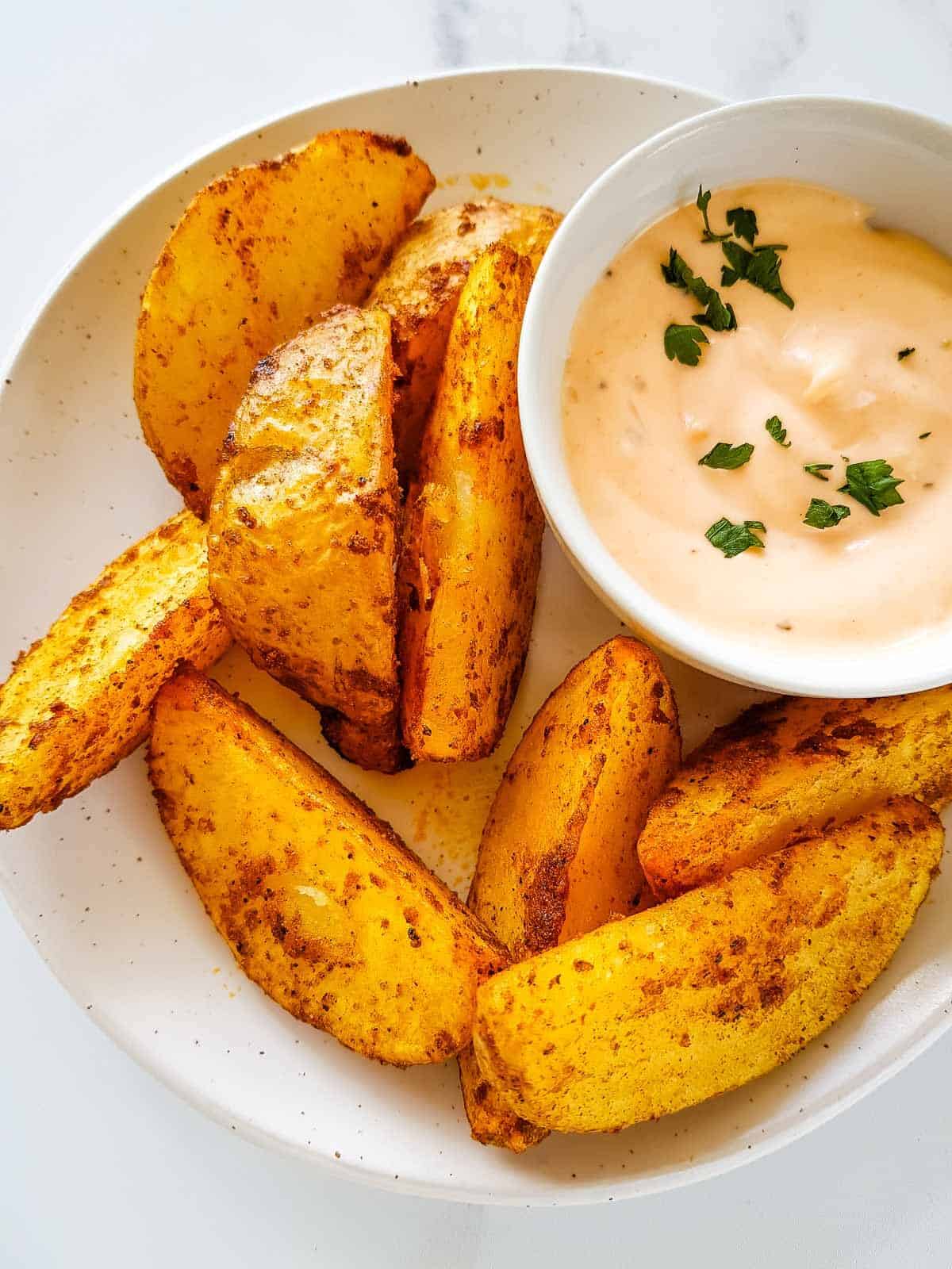 Potato wedges on a plate.