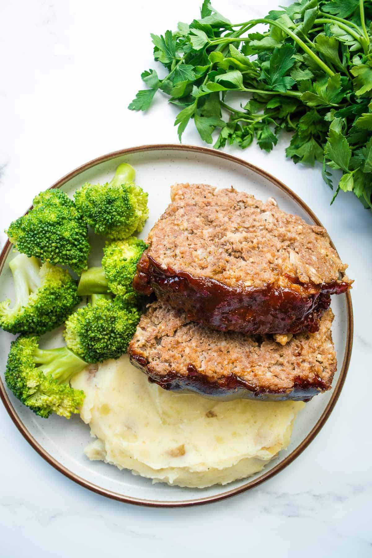 Sliced BBQ meatloaf on a plate.