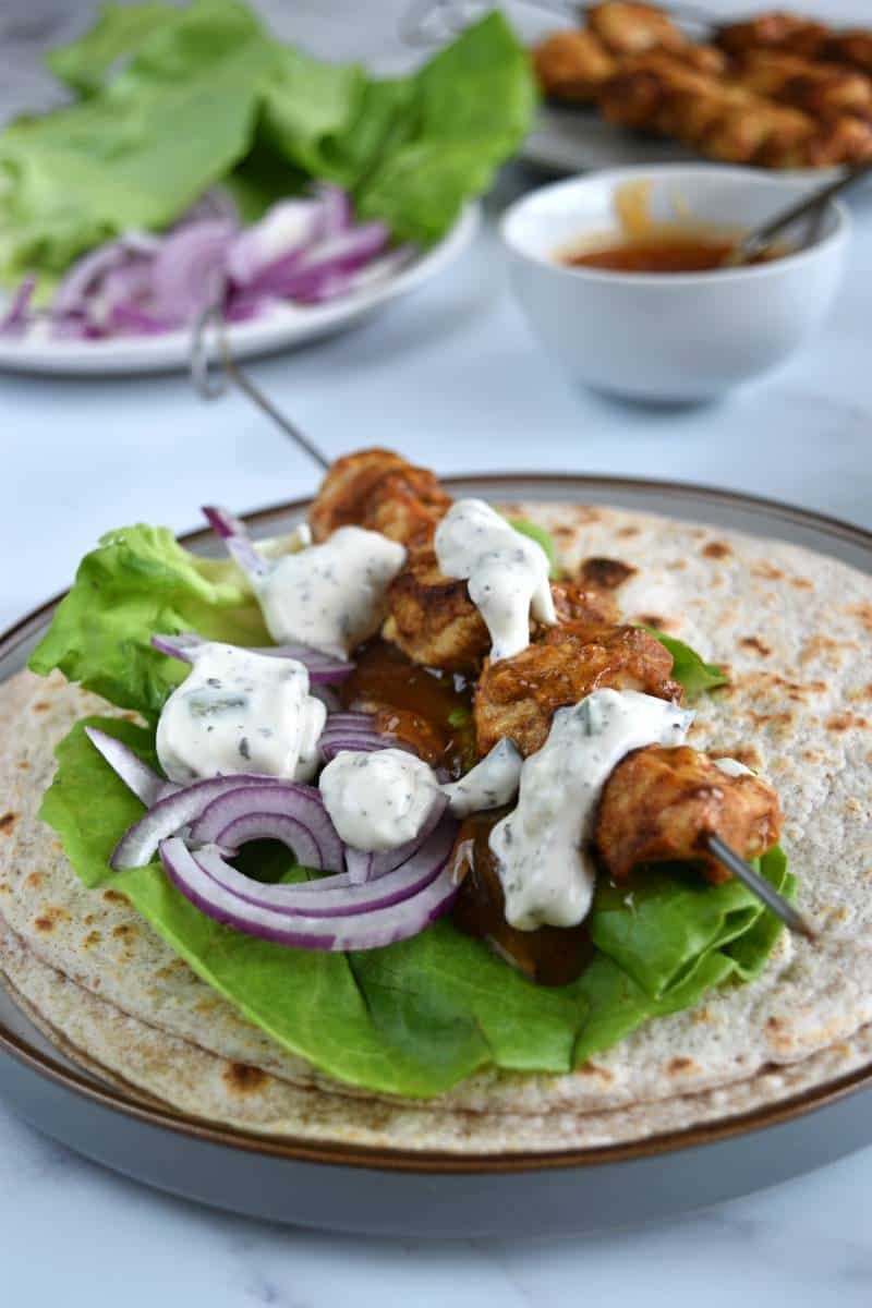 Chicken tikka wraps with raita and mango chutney.