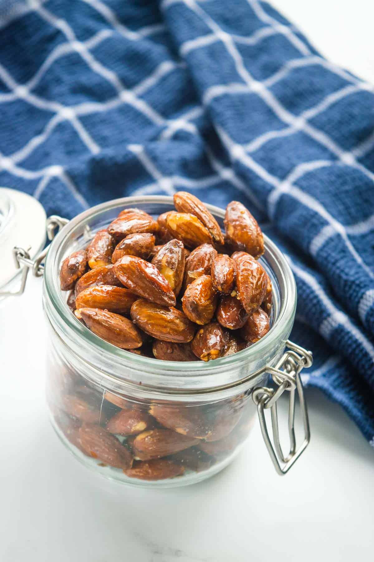 Sweet crispy roasted almonds in a mason jar.