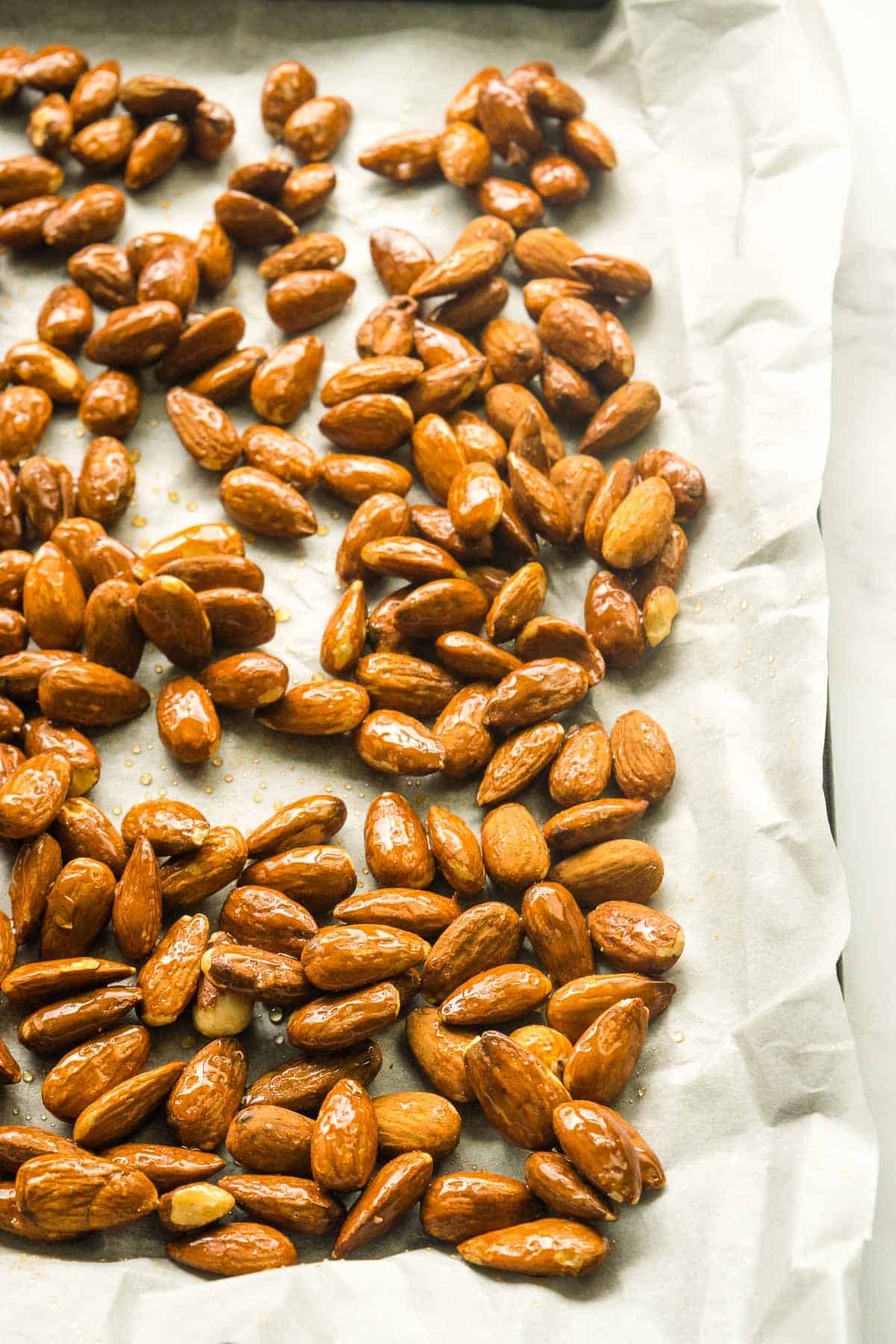 Honeyed almonds on a baking sheet.