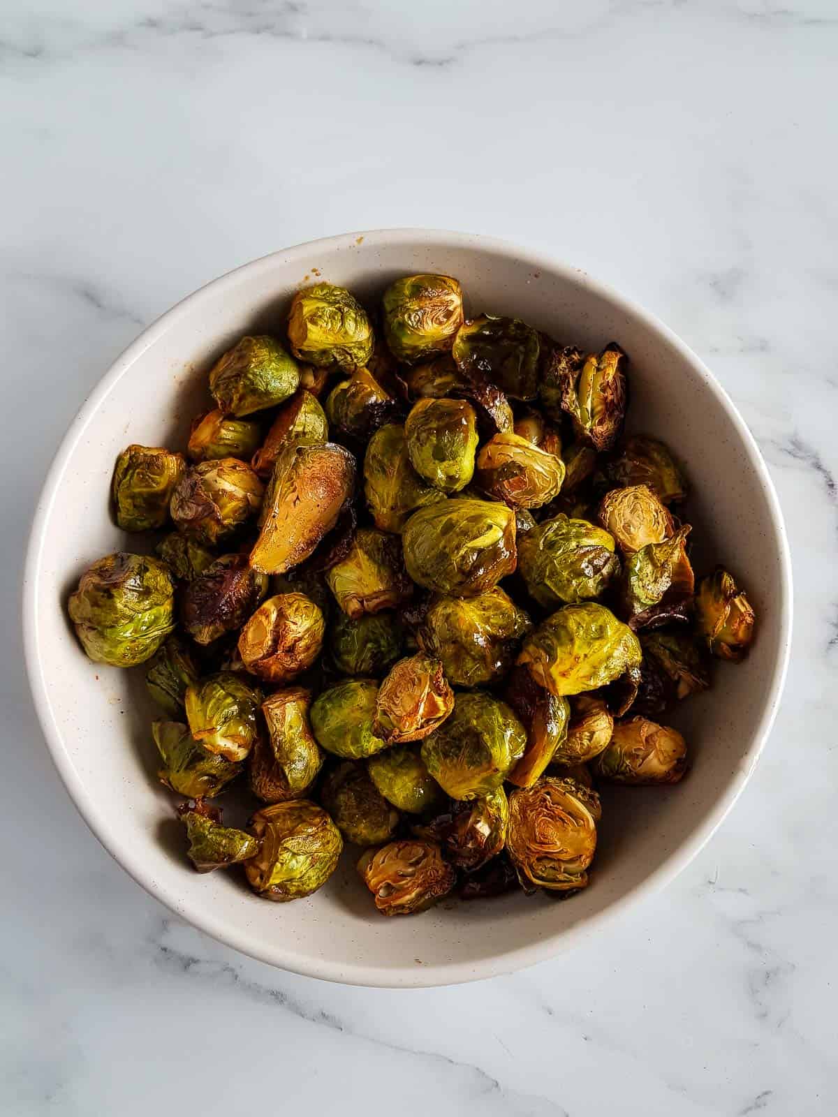 Brussels sprouts with honey and sriracha in a bowl.