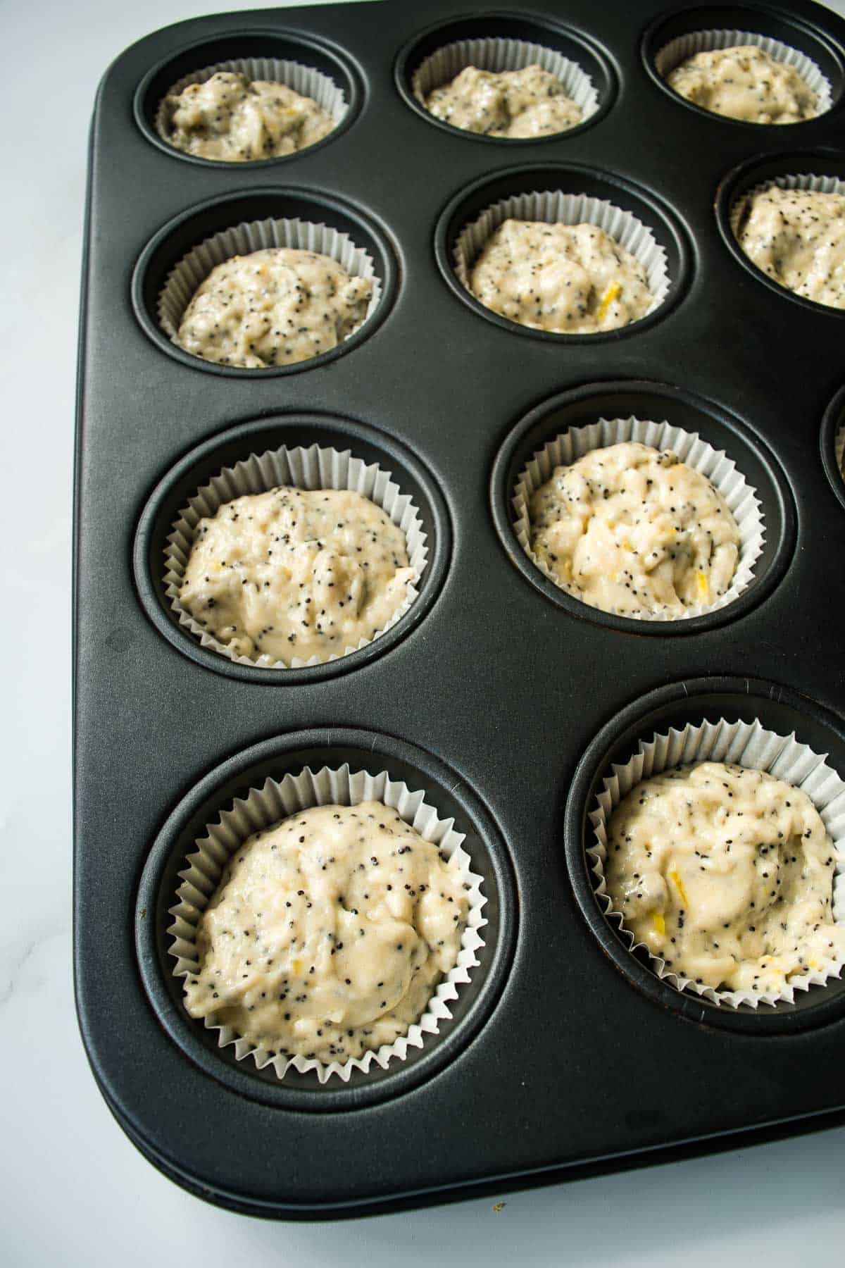 Muffin batter in muffin trays.