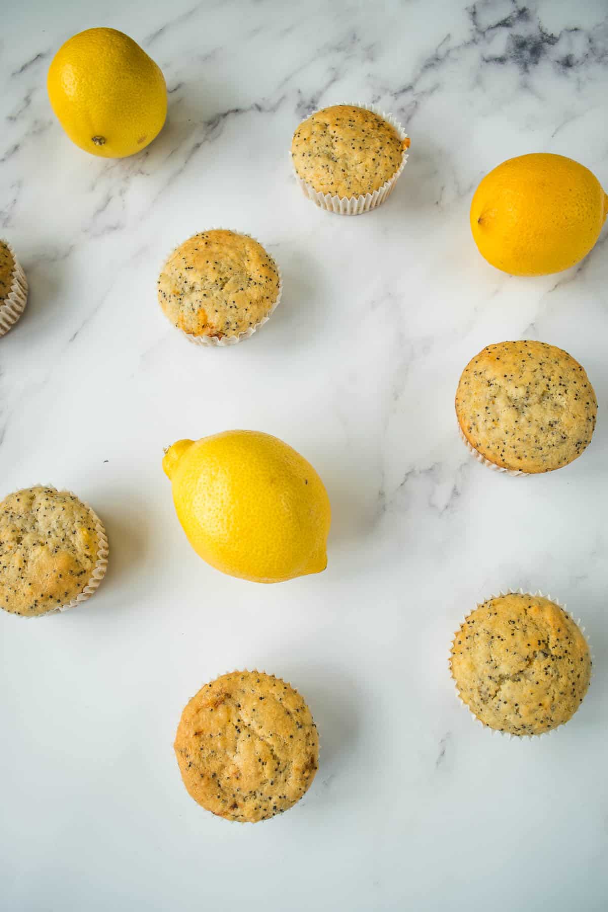 Muffins and lemons on a table.