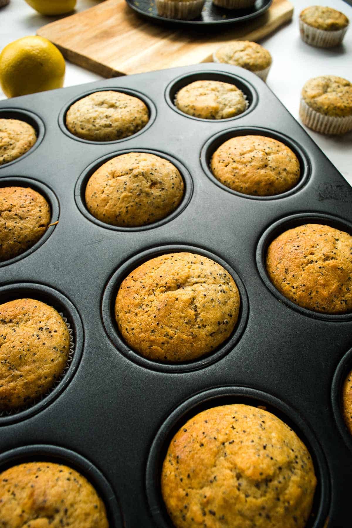 Healthy lemon poppyseed muffins in a muffin pan.