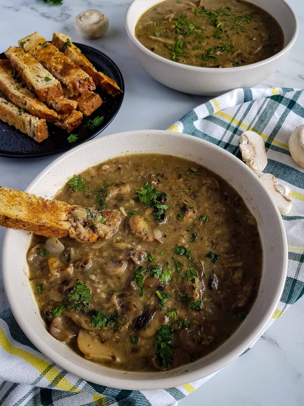 Healthy mushroom soup in a white bowl.