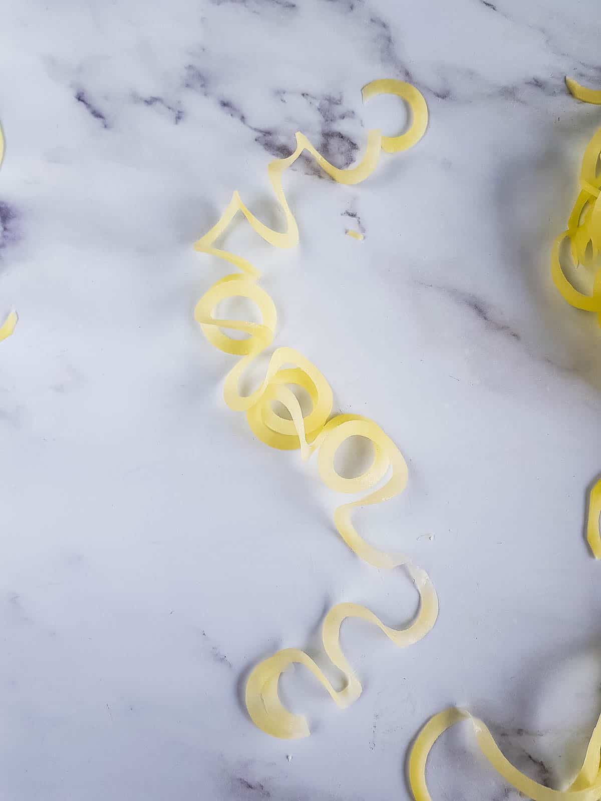 Long string of raw spiralized potato.