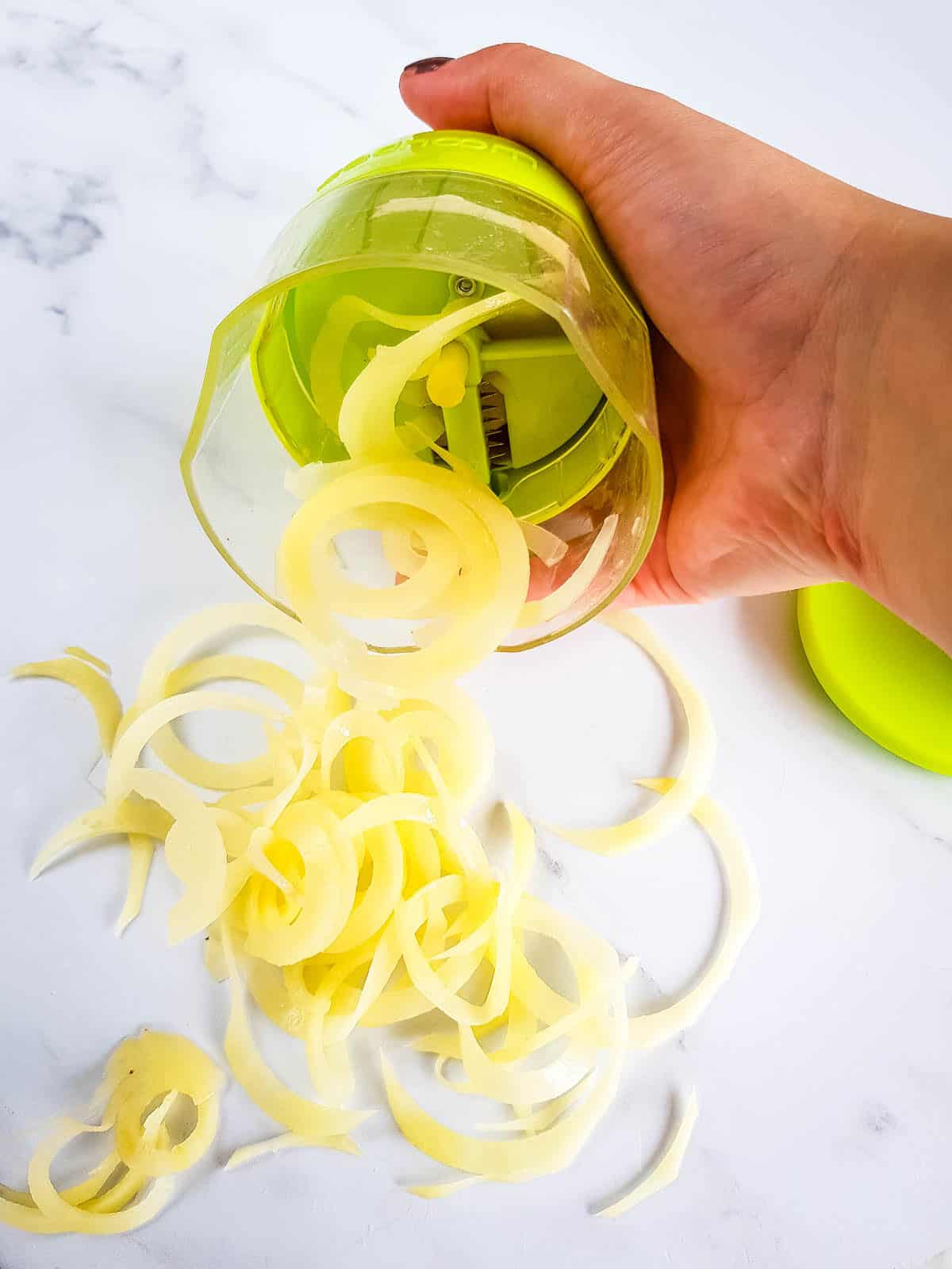 Potatoes being spiralized.