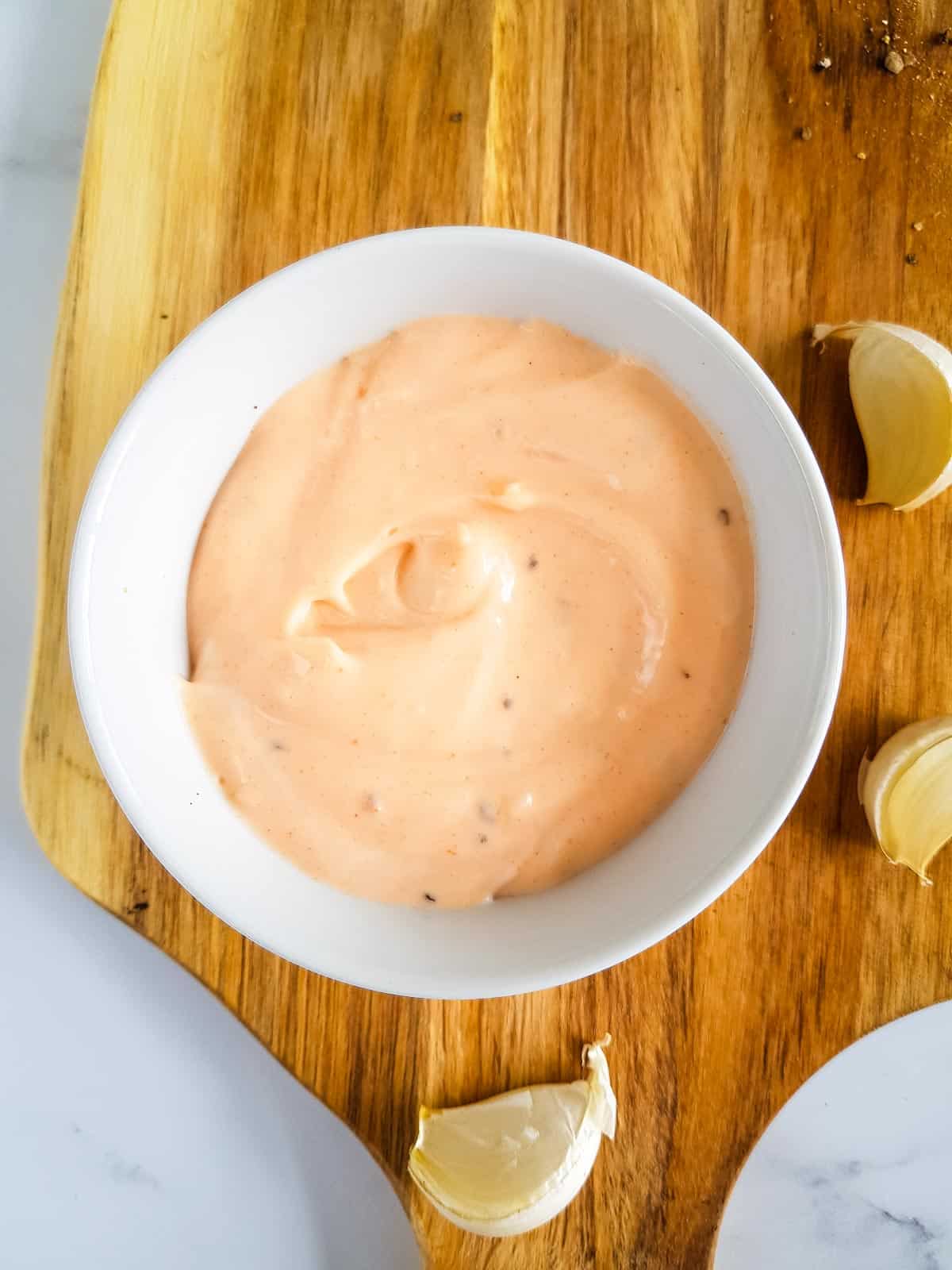 Sriracha aioli on a wooden board.