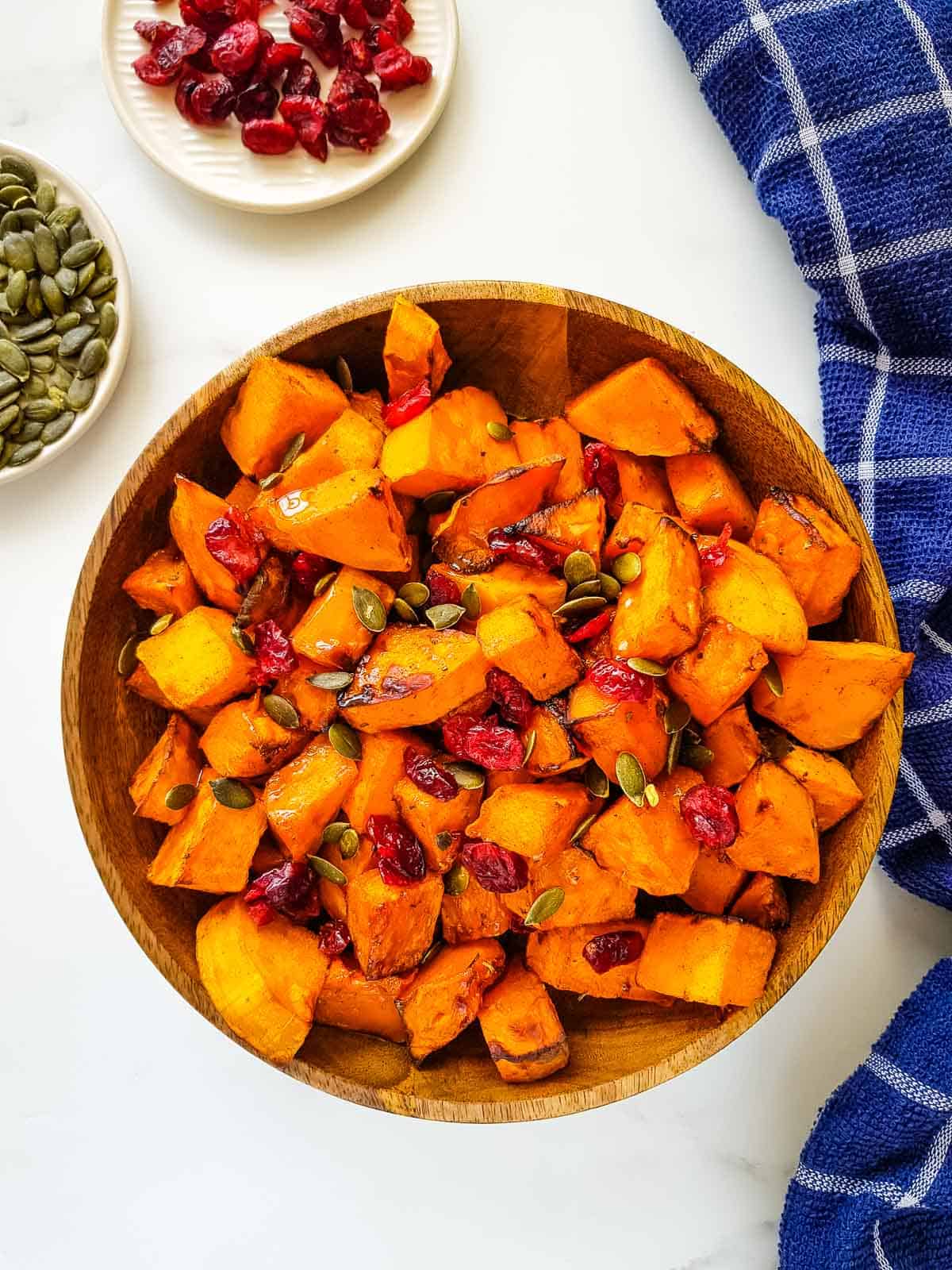 Air fryer butternut squash with pumpkin seeds and cranberries.