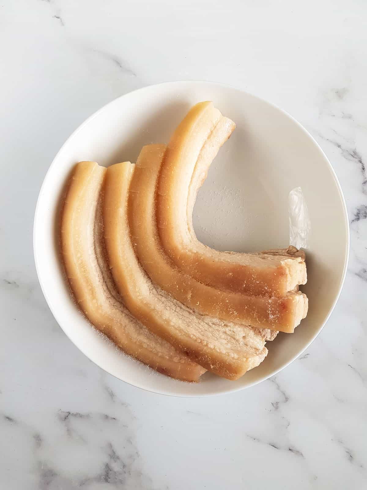 Boiled pork belly in a shallow bowl.