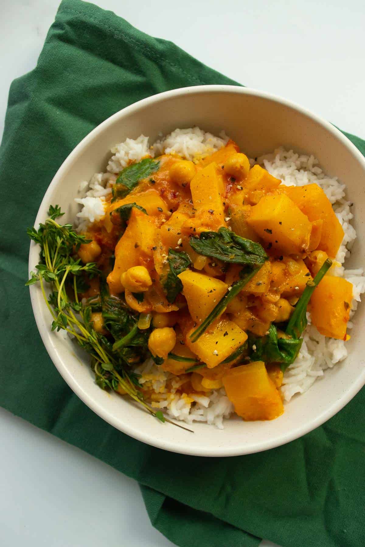 Butternut squash curry in a bowl over rice.