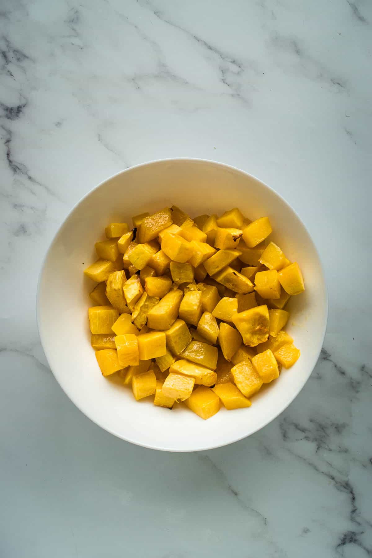 A bowl with roasted butternut squash.
