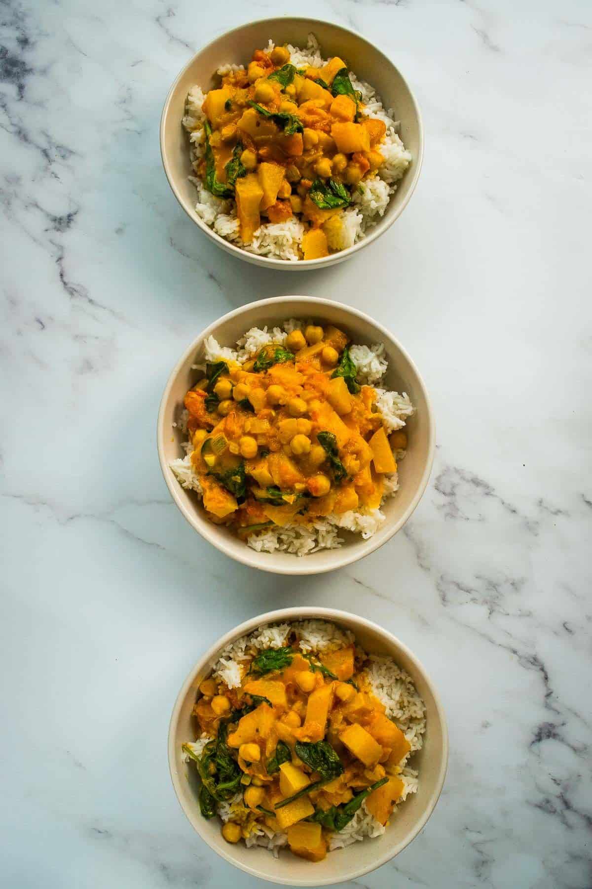 Three bowls of butternut squash curry.