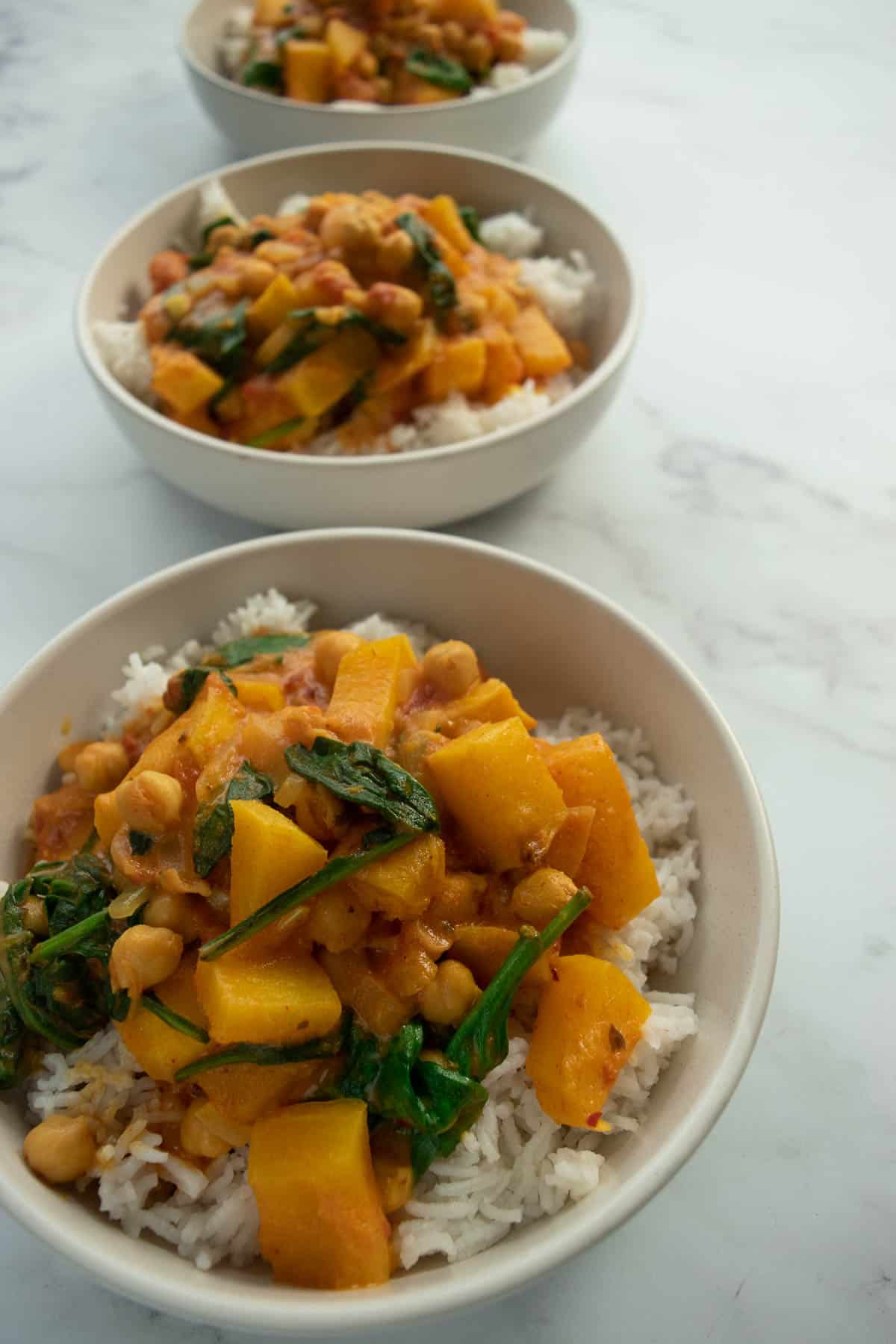 Bowls of butternut squash chickpea curry and rice.