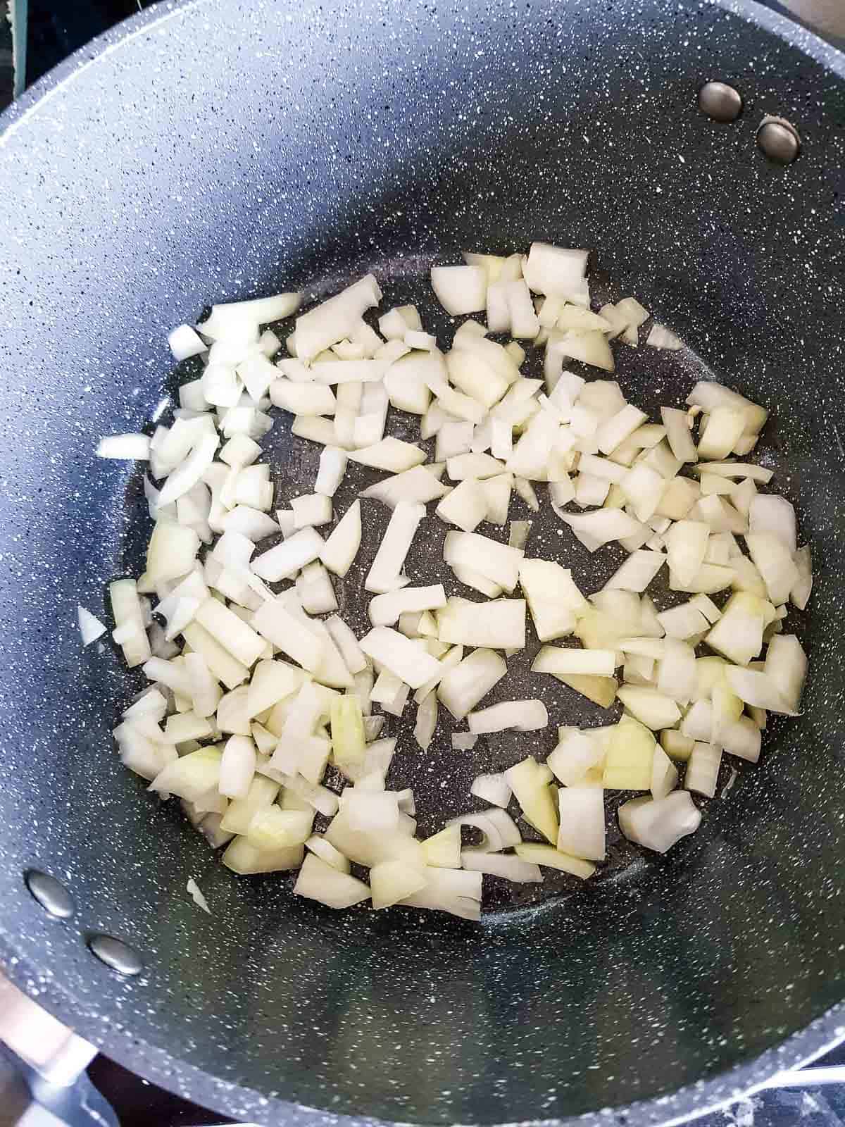 Sauteeing onions in a pot.