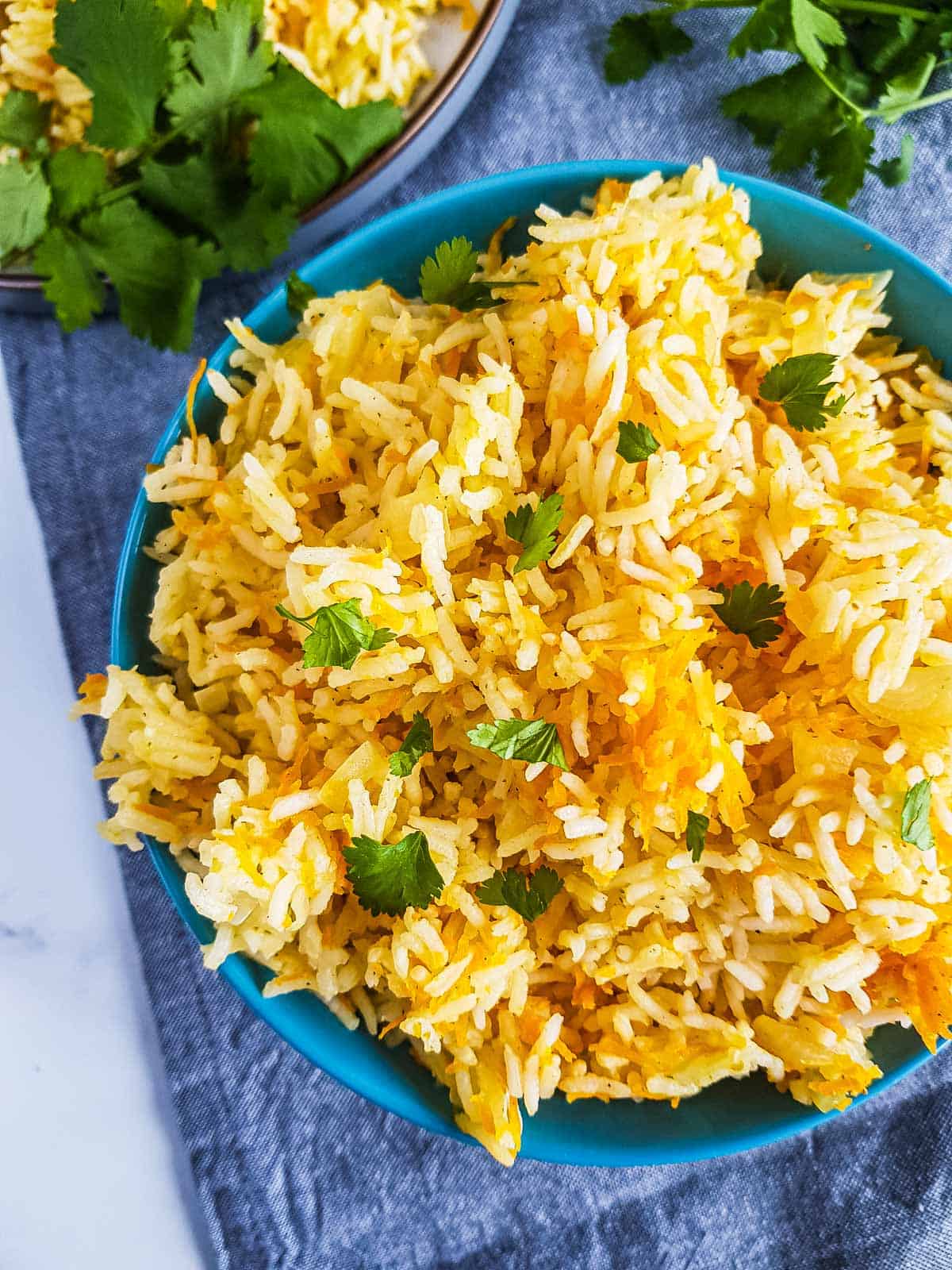 Close up of rice with grated carrots.