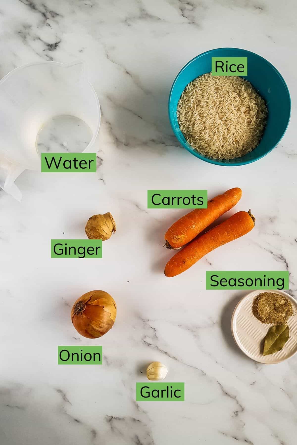 Ingredients for carrot rice laid out on a table.
