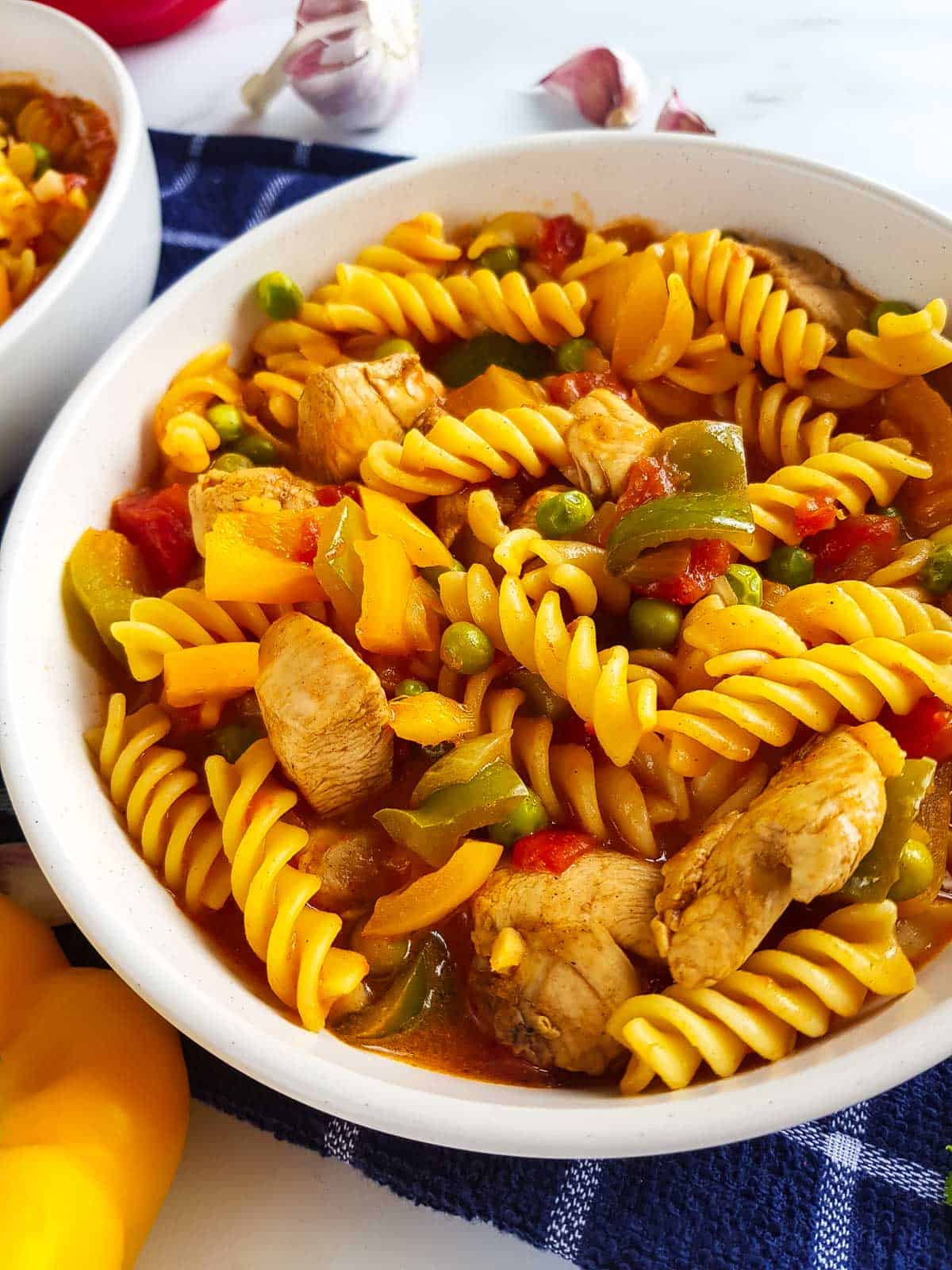 Close up of a bowl with chicken curry pasta.