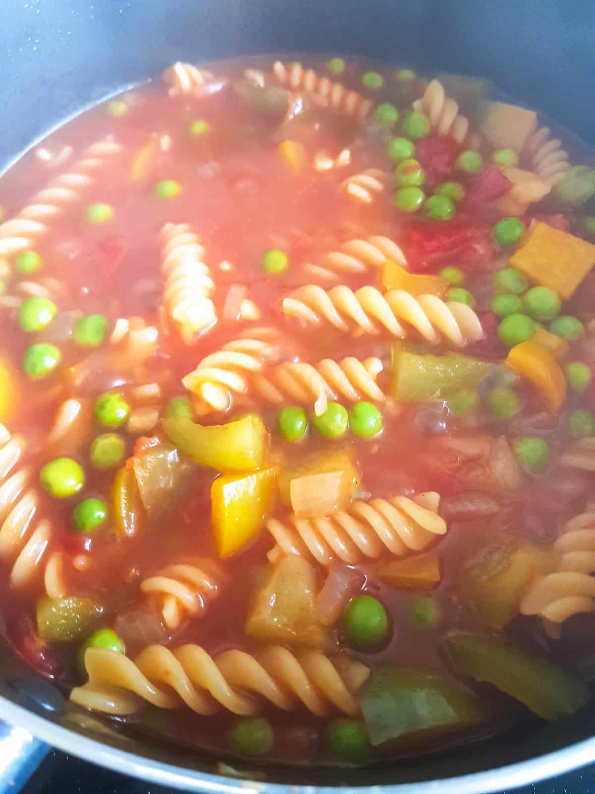 Peas, chicken and tomatoes added to the pasta.