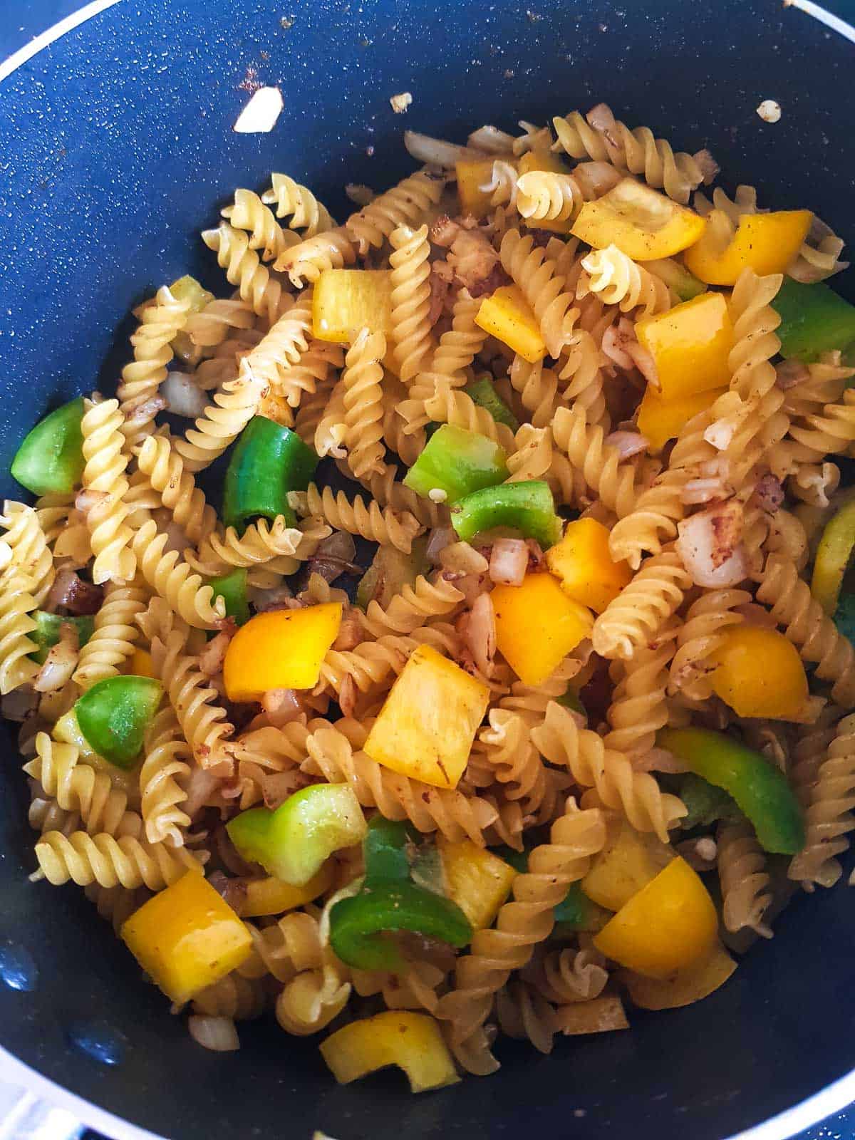 Pasta and peppers added to the onions.