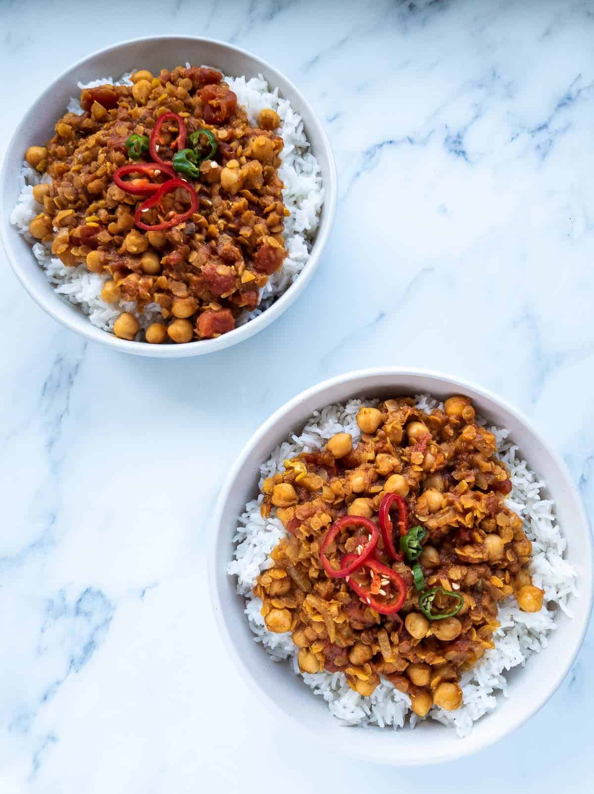 Two bowls of lentil and chickpea curry.