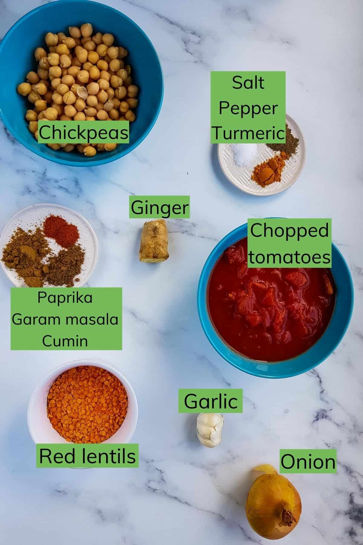 Ingredients for chickpea and lentil curry laid out on a table.