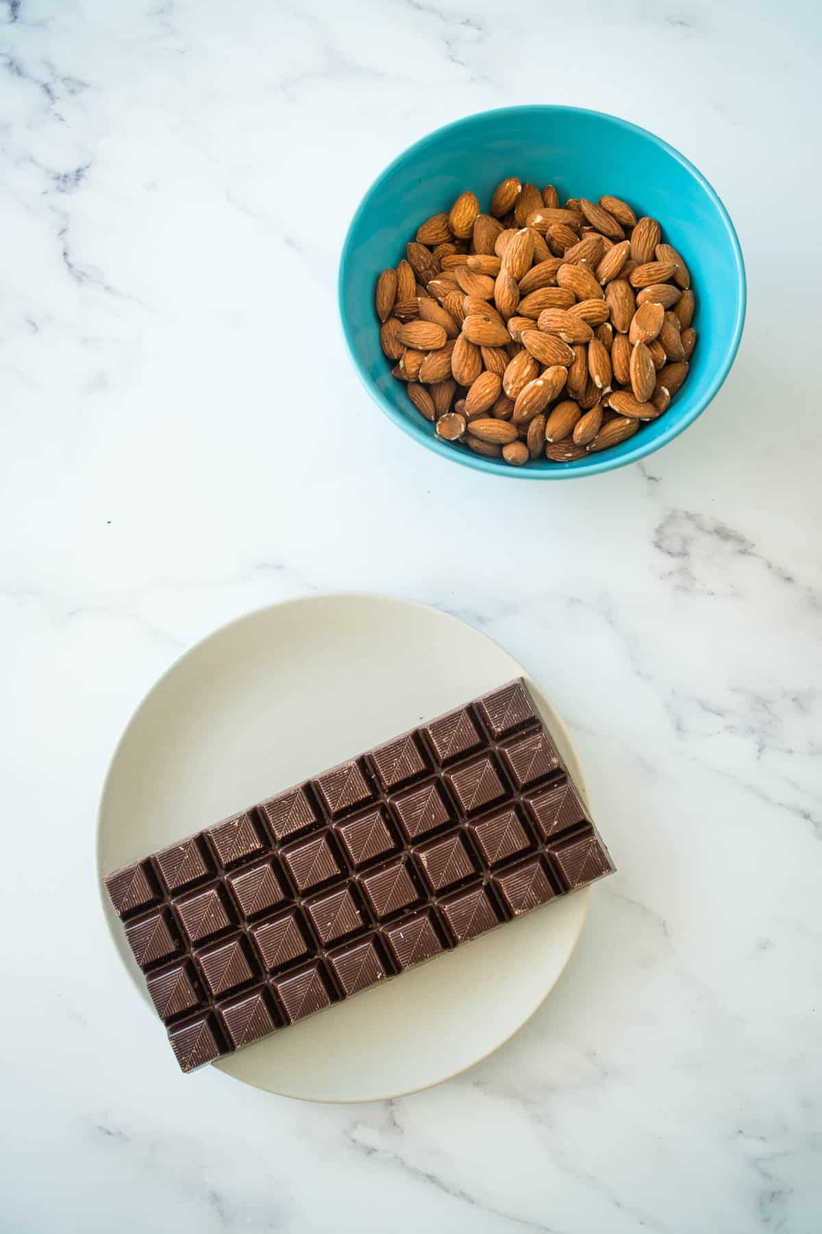 Chocolate and almonds on a table.