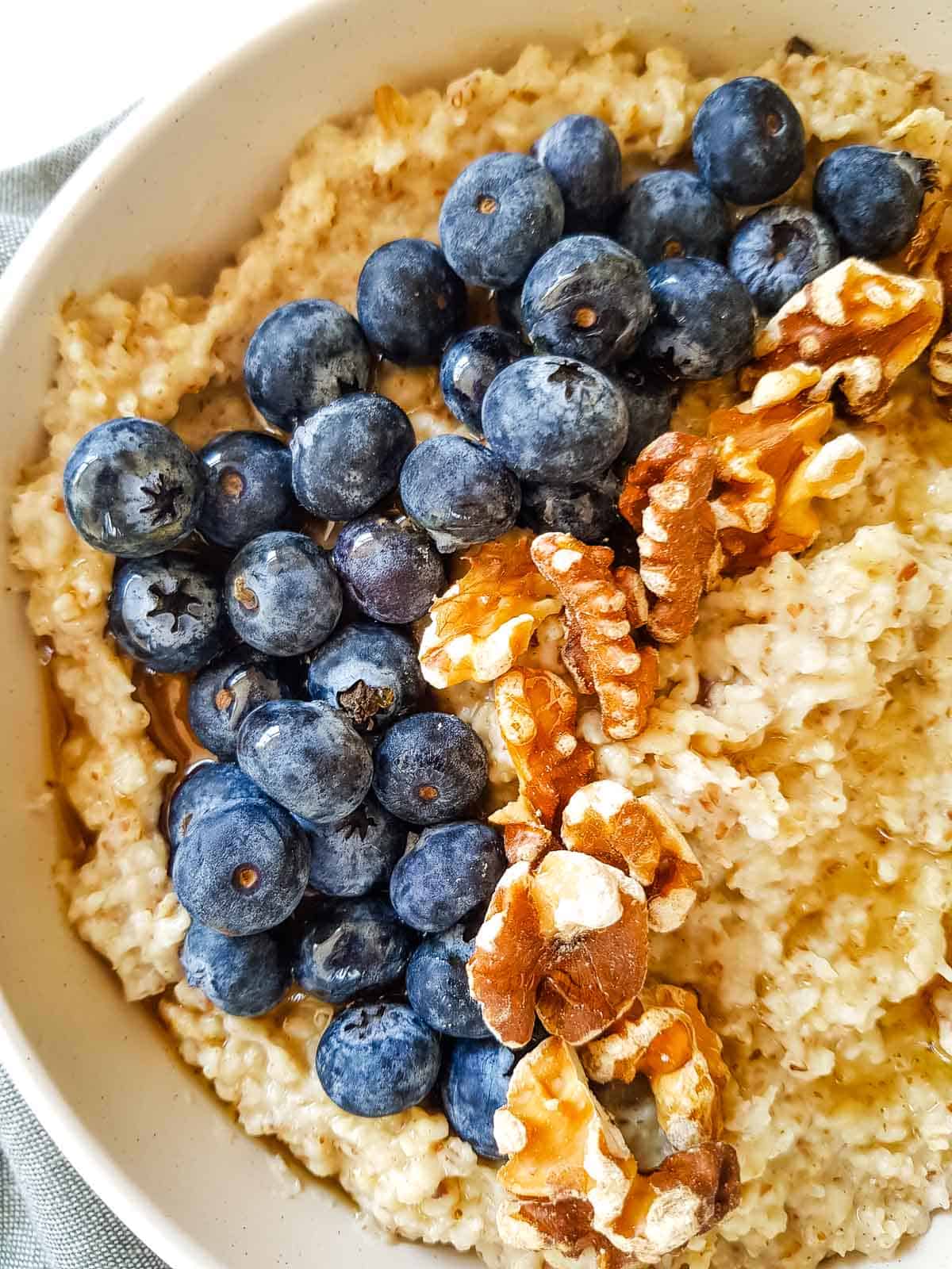 Close up of oatmeal topped with blueberries.