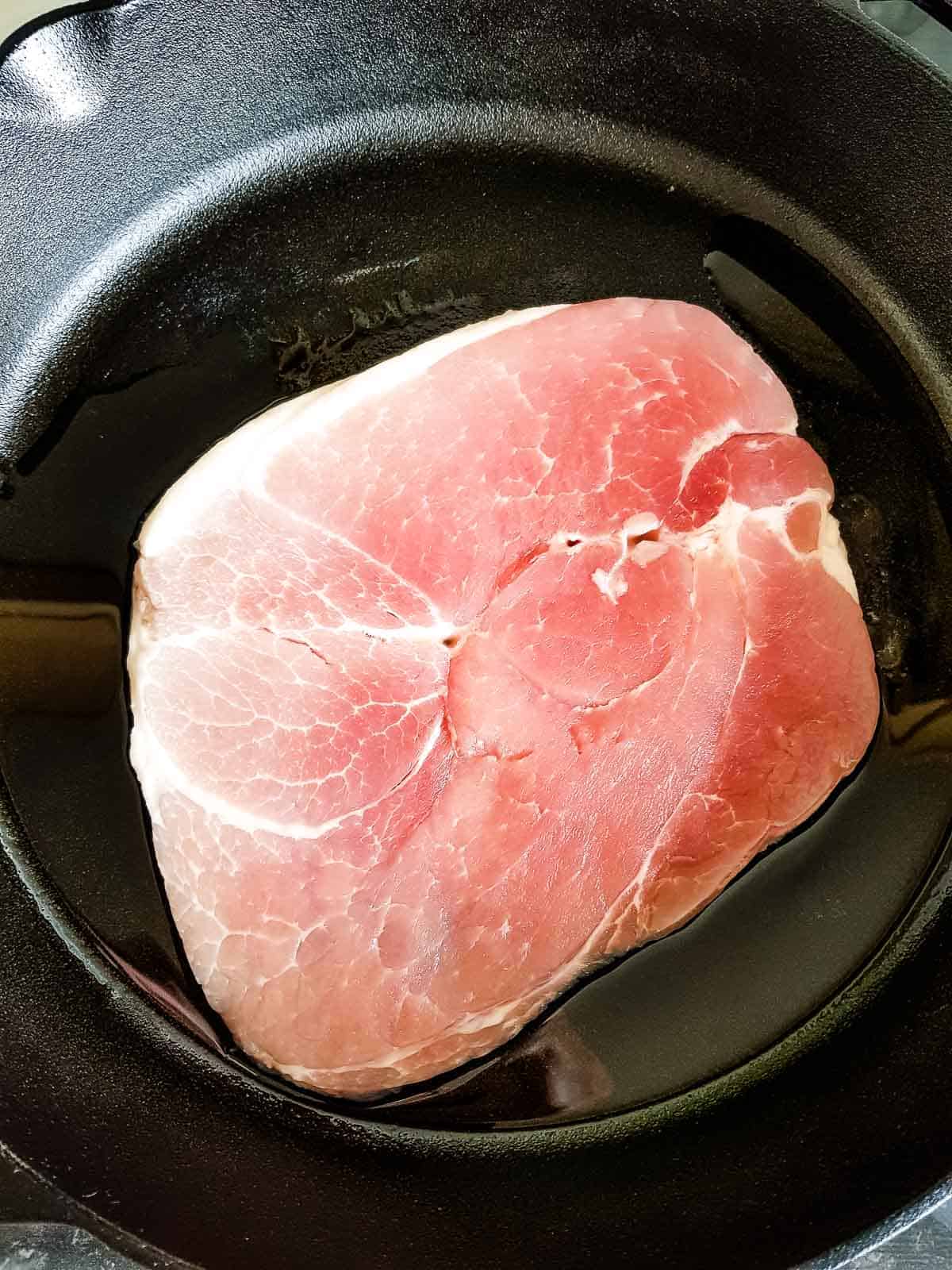 Gammon steak in a cast iron pan.