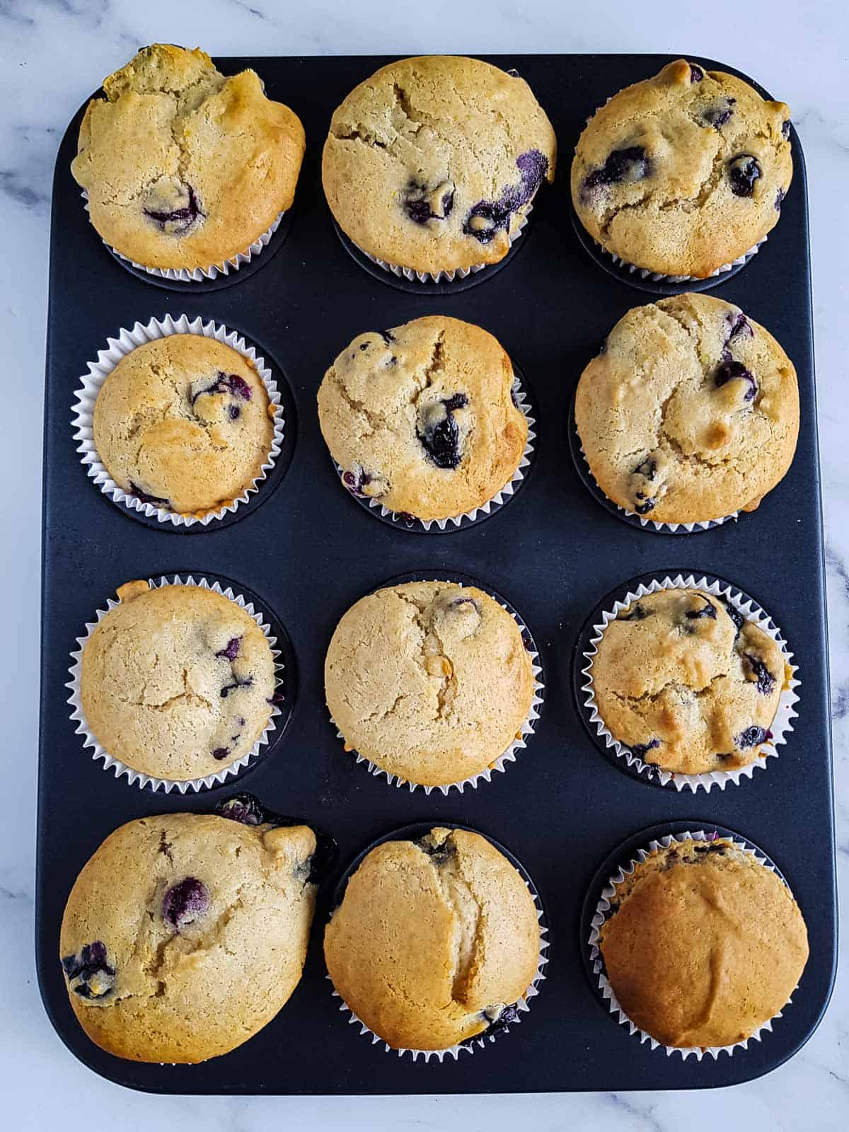 Cooked muffins in a muffin pan.
