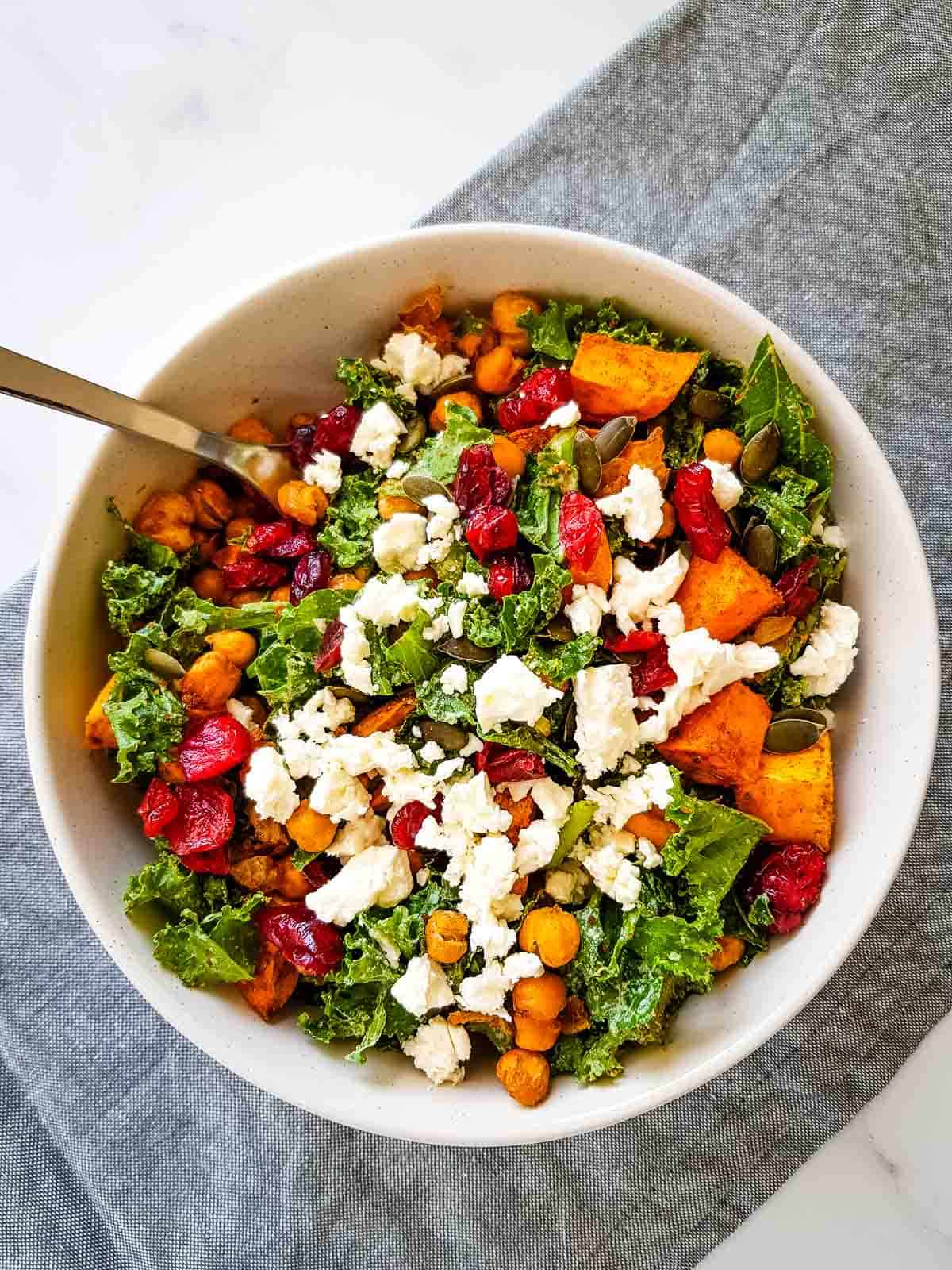 Salad in a bowl with a fork in it.